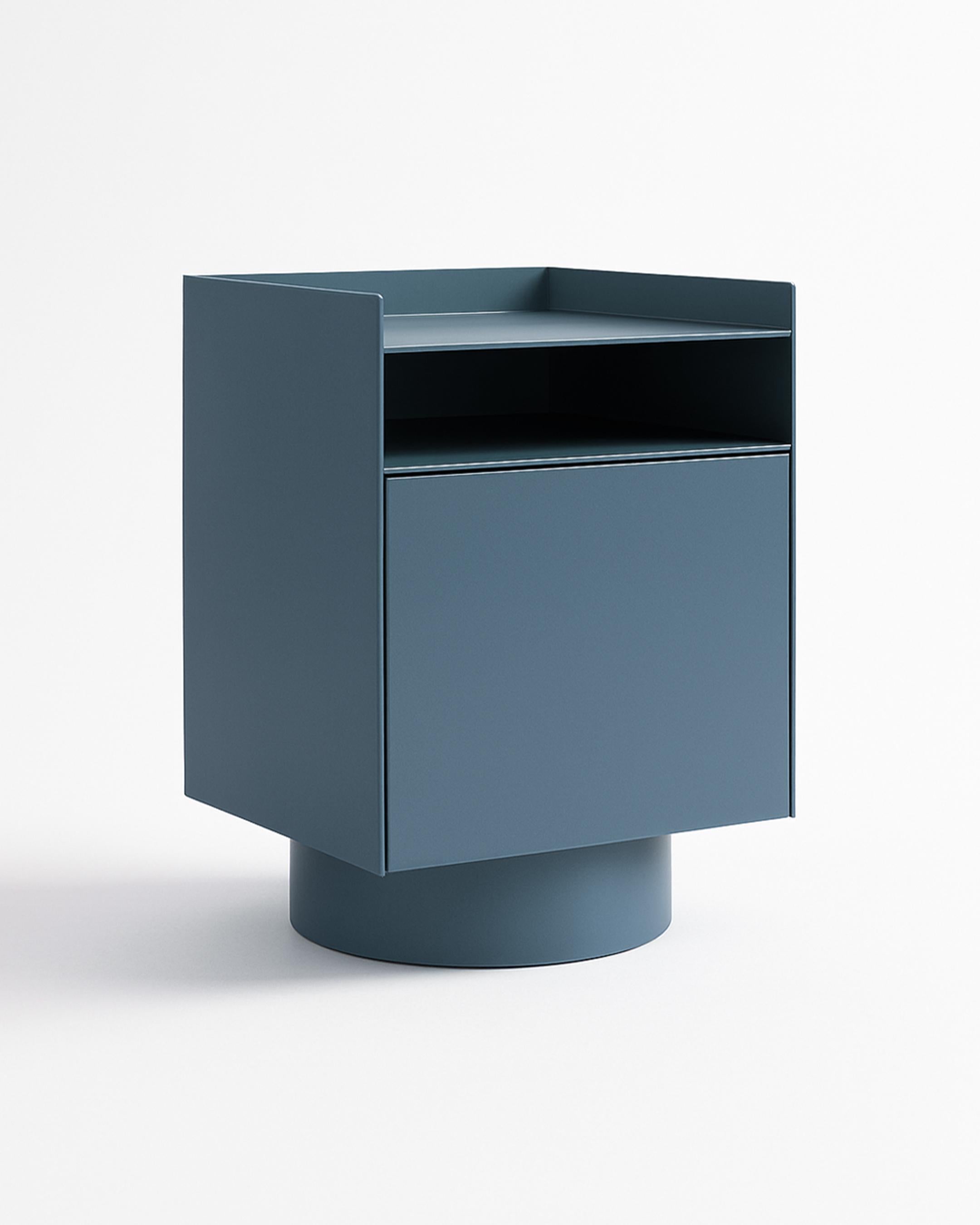 Bloc is a modern nightstand defined by bold lines and architectural simplicity. Elevated on a cylindrical base, its form feels both grounded and visually balanced.

An open upper shelf keeps essentials like books, glasses, or your phone close at