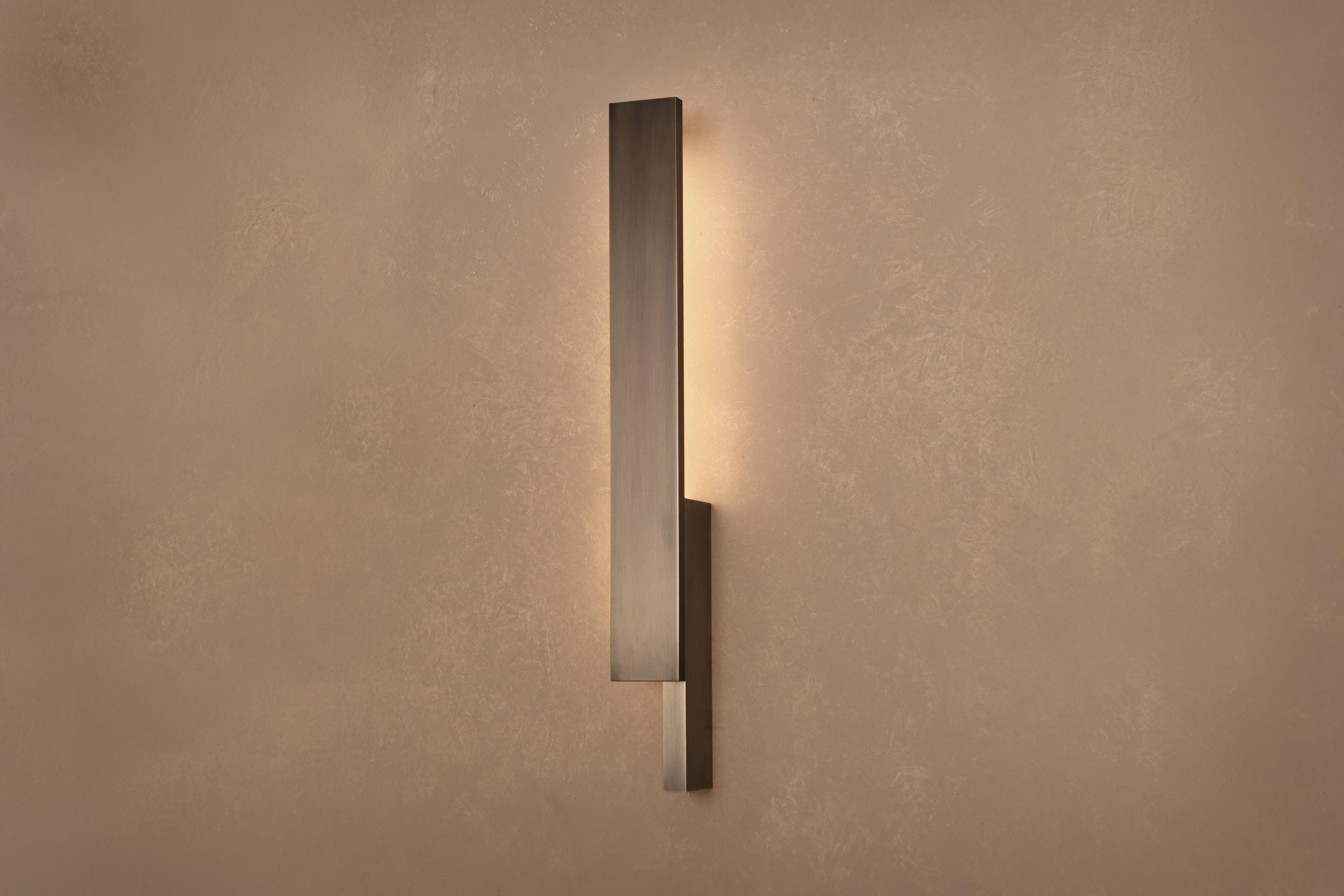 L'applique Bloc s'inspire de la sculpture minimaliste classique des années 1960, réimaginée par un jeu de blocs solides et entrecroisés. Son design asymétrique permet des combinaisons à gauche et à droite, ce qui le rend adaptable à toute une série
