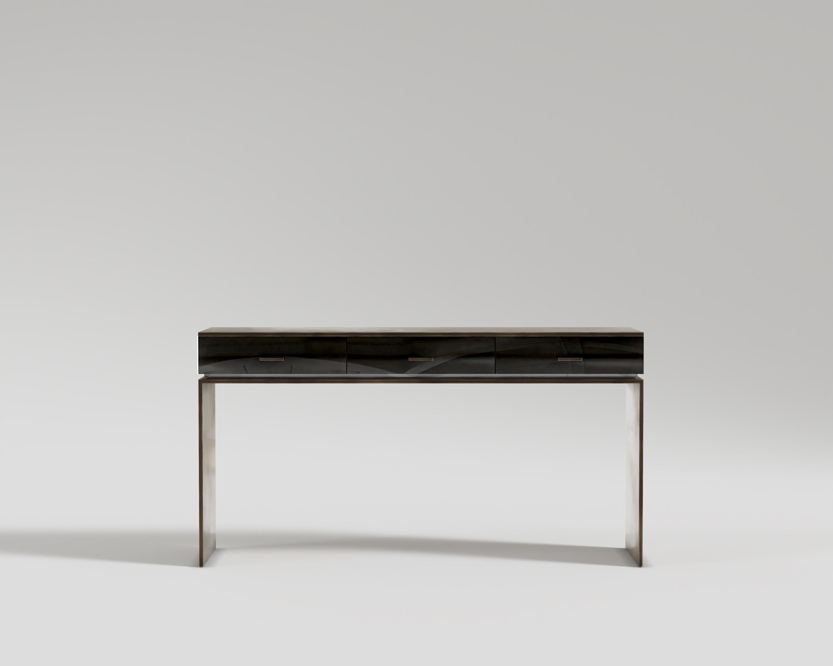 Block Console
Fresh, and captivating embodiment of the Block console sweep you into a floating of delight. The gorgeous patine bronze is a beautiful contrast to the black lacquer and plexiglass which gives us a masterpiece of modernity.

Materials