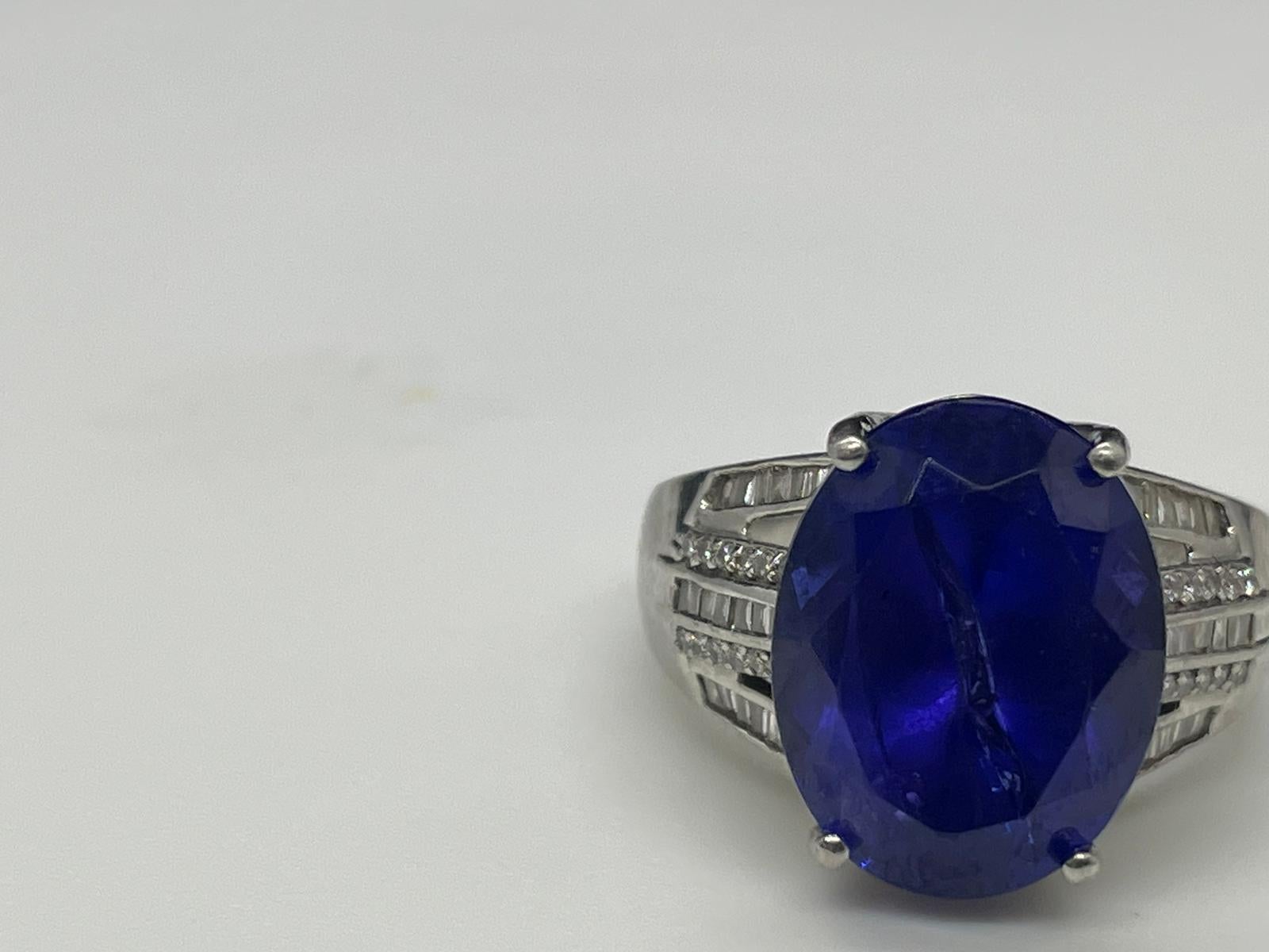 Stunning collector's piece with 11.55 CTW Tanzanite with .45 CTW sparkling E/F color and VS2 clarity diamonds.  The Tanzanite is a vivid blue/purple expertly crafted in luxurious 12.0g of platinum and would be a great engagement ring.  

Size:  8.5