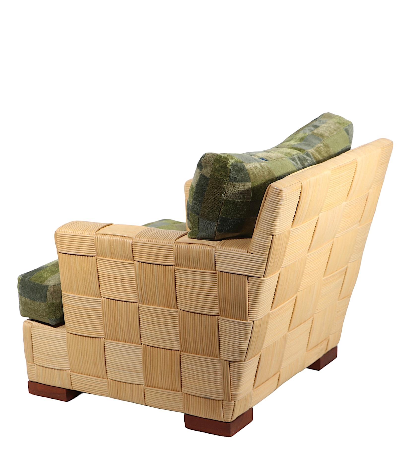 Chic, voguish, sophisticated Block Island  club chair designed by John Hutton for Donghia, circa 1990's. The chair features a  woven rattan patchwork pattern surface, on mahogany feet, with original block pattern seat and back cushions. 
 The Block