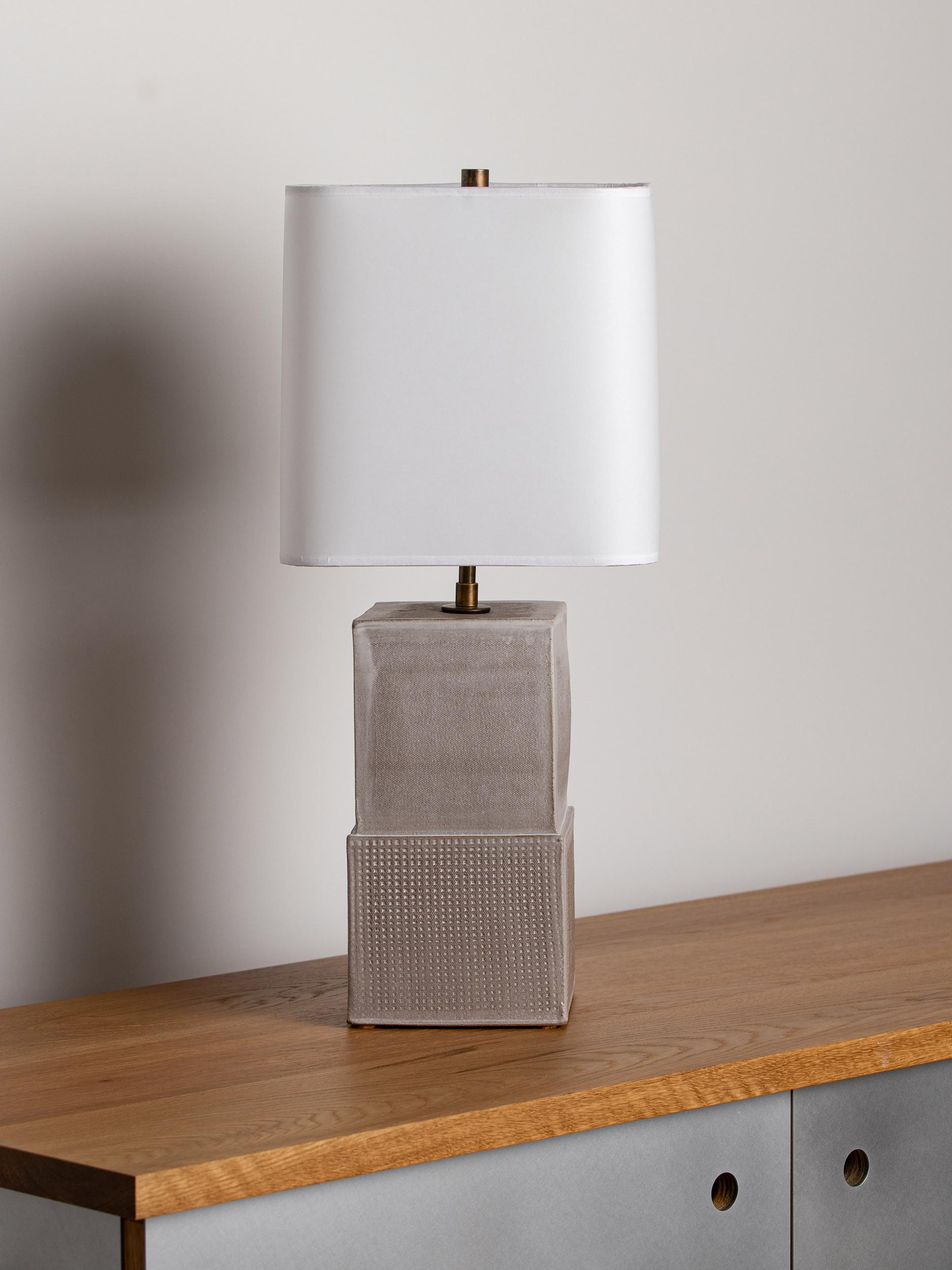 Our stoneware Block lamp is handcrafted using slab-construction techniques. The lamp’s pattern is created by rolling the surface with textured rolling pins and rods.

Finish

- Dipped glaze, pictured in chalk 
- Antique brass fittings
-