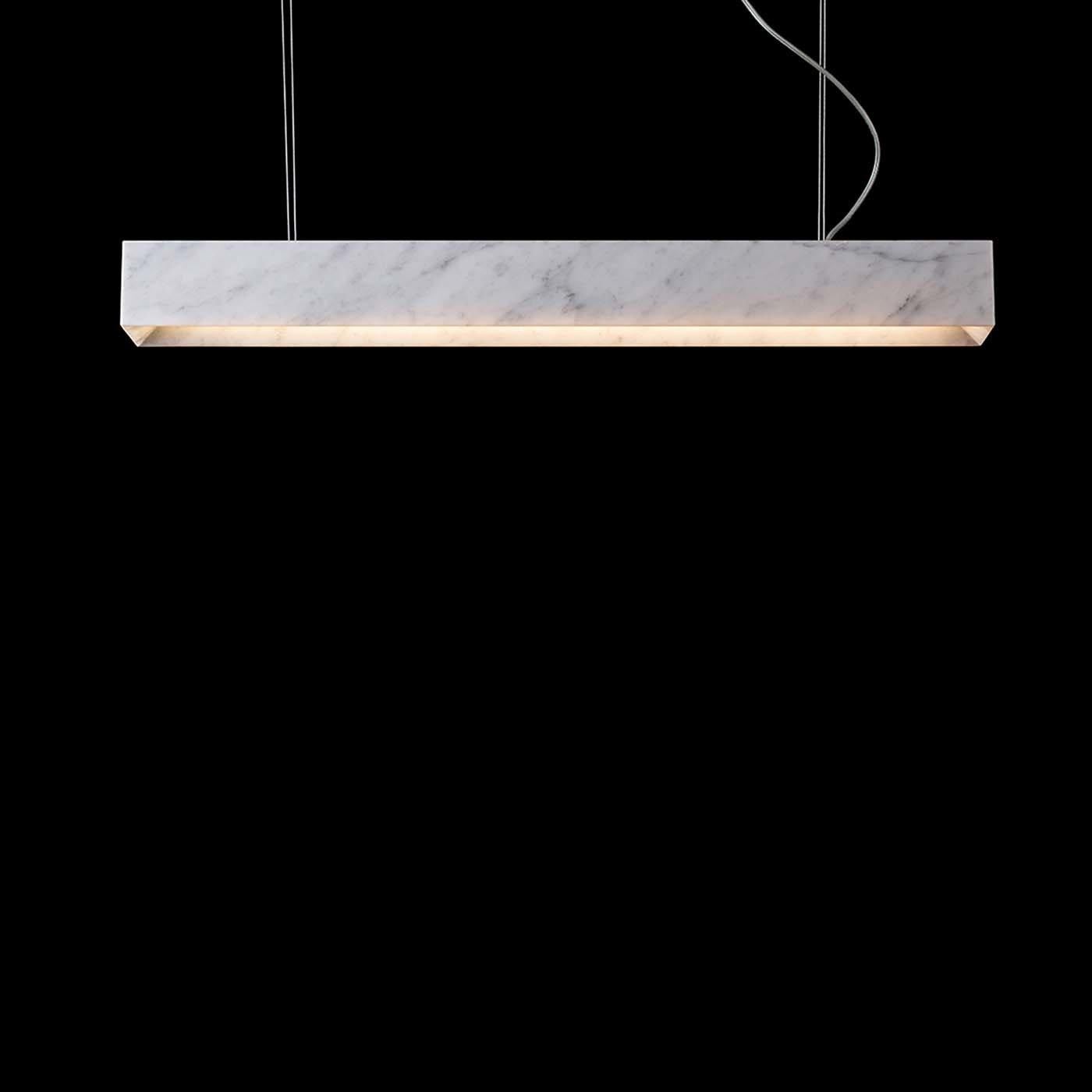 This is a minimalistic LED suspension lamp designed by Gerardo Mari. This piece is completely made in premium white Carrara marble and is ideal for spacious environments. The electronic components are subtle and perfectly blended with the design.