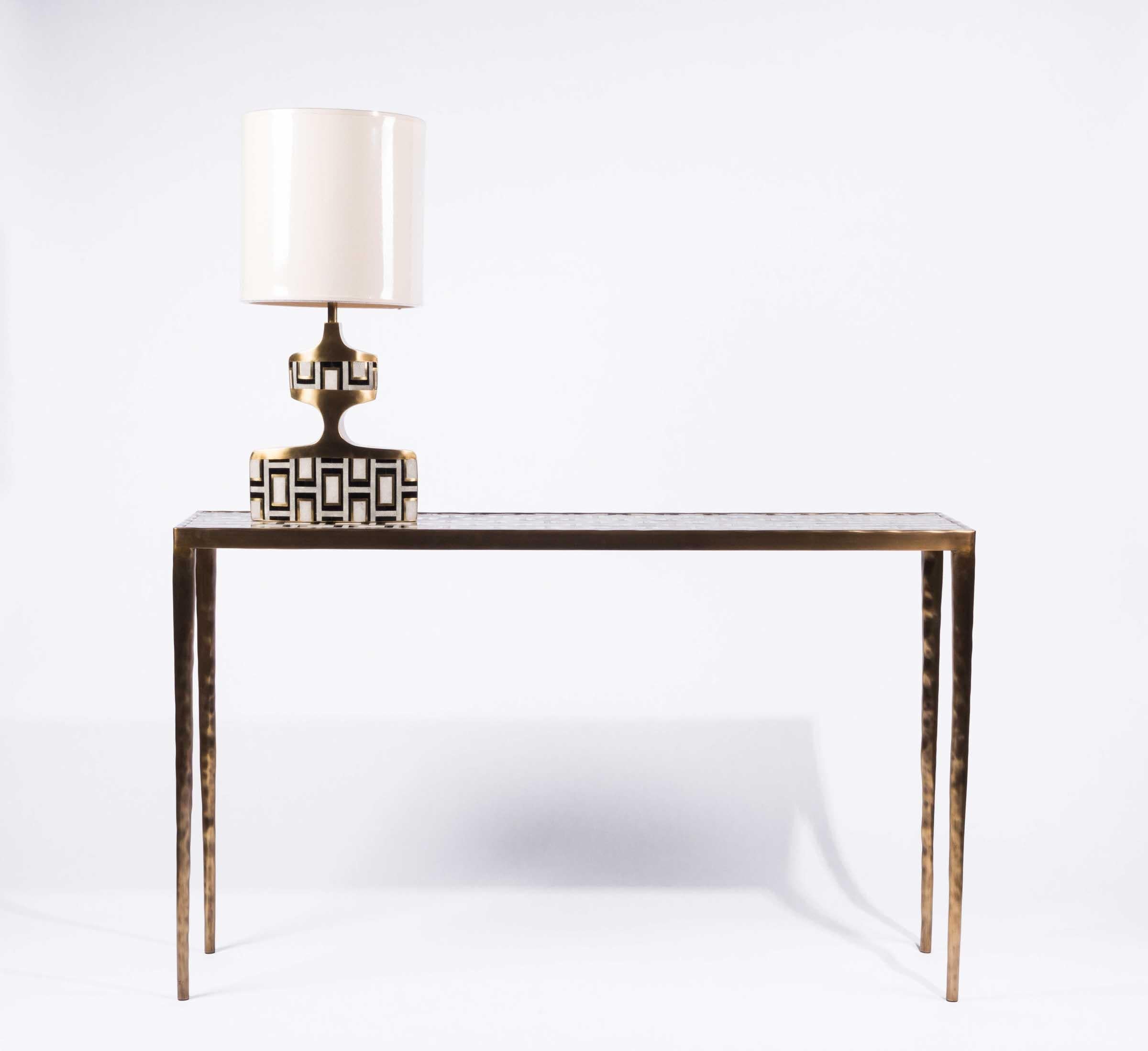 The block pattern console inlaid in a mixture of cream shagreen, coal black pen shell and bronze patina brass demonstrates the incredible hand-craftsmanship of Augousti. The geometric pattern against the simple but elegant shape of the console,
