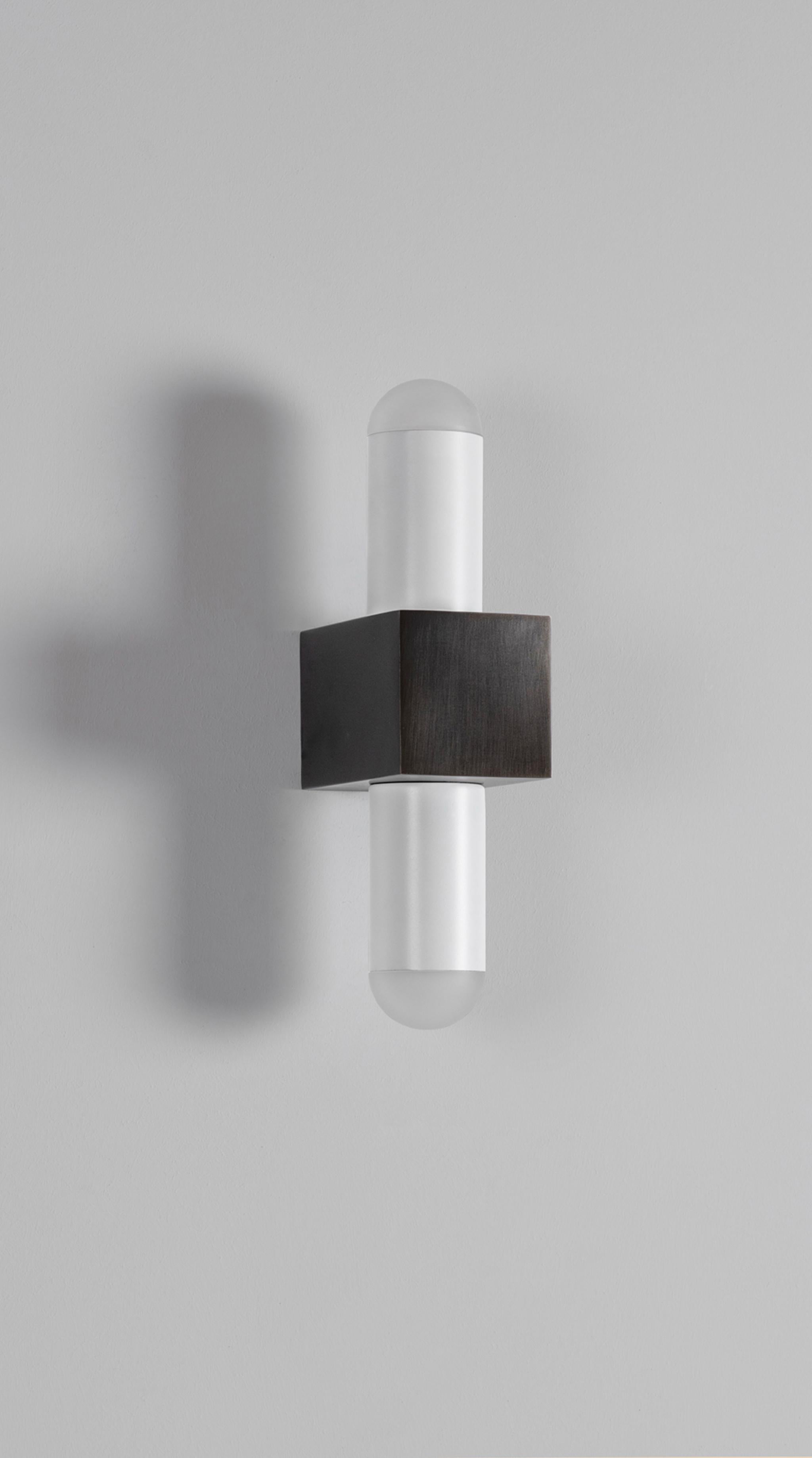 Block wall lamp by Square in Circle, 2022
Dimensions: W 7 x H 28 cm
Projection: 11.5 cm
Materials: Dark bronze, opaque glass, powder coated matt white

A clean and simple wall light inspired by the Bauhaus approach, which focuses on geometric