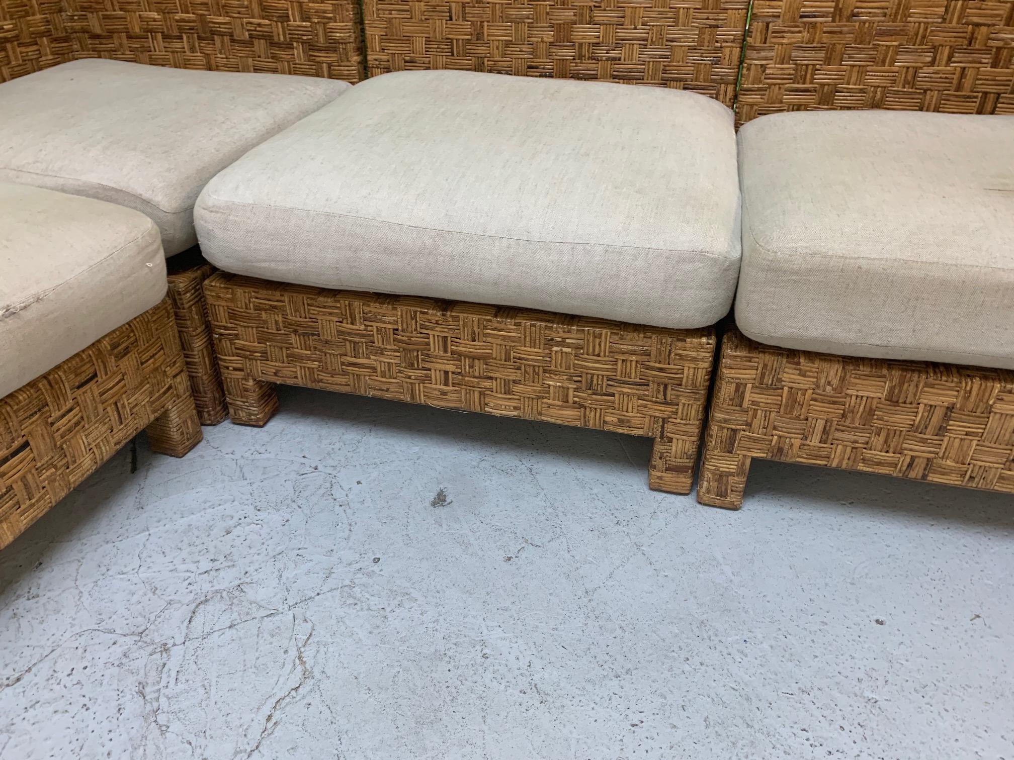 5-piece sectional sofa features woven block wicker design and modular pieces that can be arranged in several configurations. Design in the manner of John Hutton. Consists of 2 corner pieces, 2 side pieces, and an ottoman piece. Good vintage