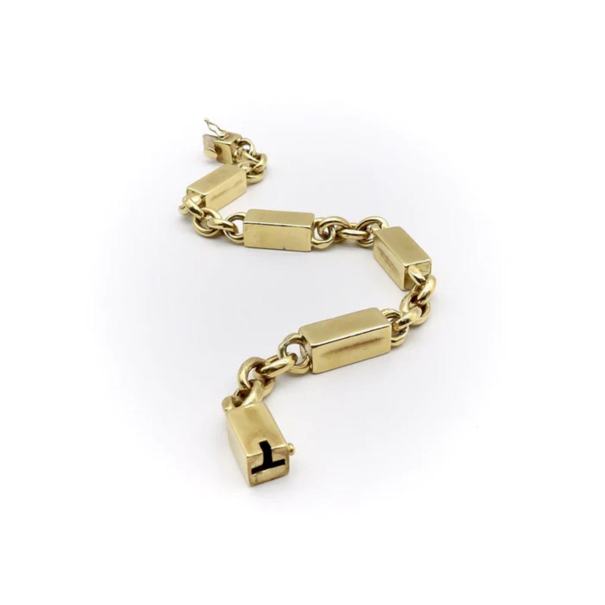 This bold, 1980's bar and link bracelet is made of 18k gold and is sure to make you stand out from the crowd. The large brick-like links are hard to miss and are tied together by equally eye-catching oval links. While this is a heavy bracelet, the