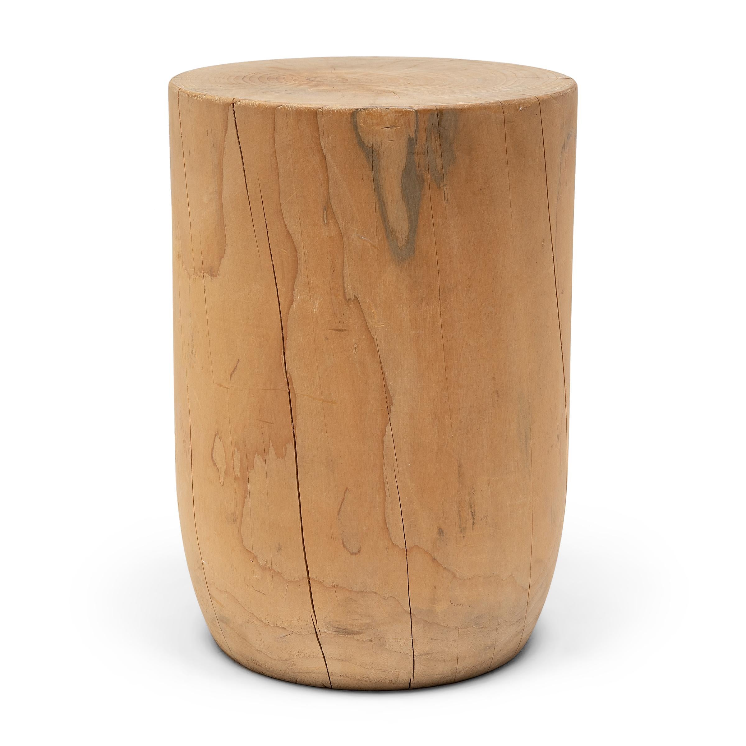 This modern side table was carved from a solid block of reclaimed wood and left unfinished to celebrate its natural blonde color and fantastic wood grain. The low trunk table boasts a minimalist design, sculpted with a flat top surface and a tapered