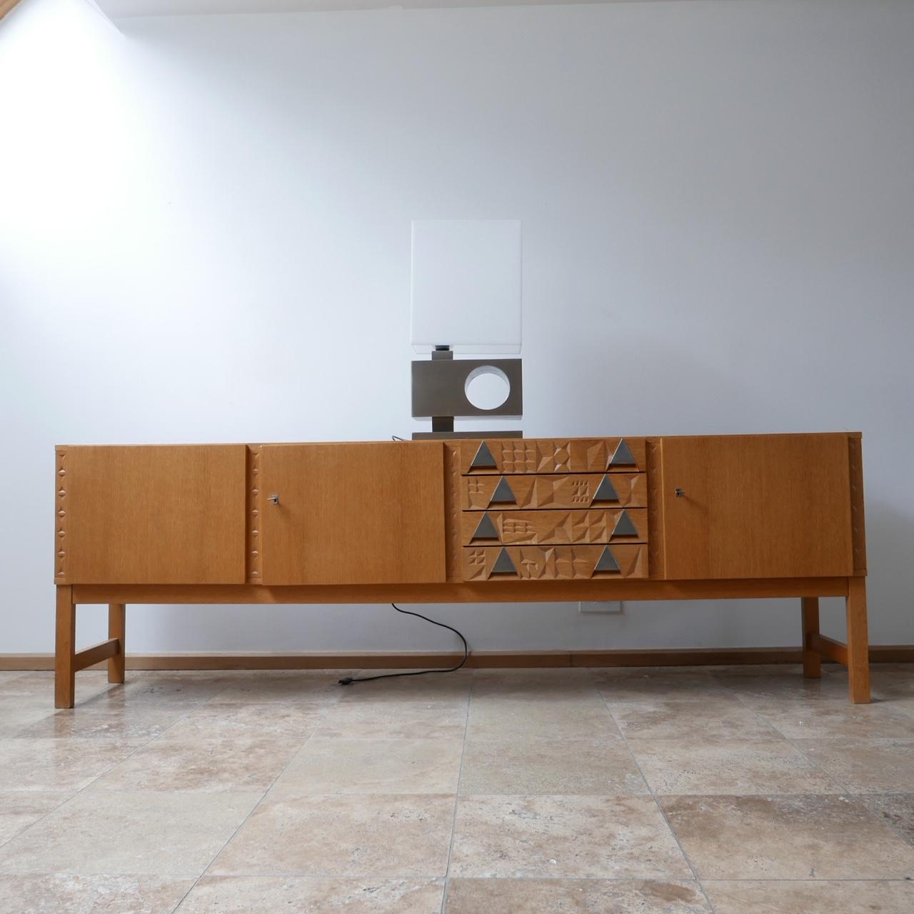 A good quality French midcentury credenza/sideboard.

Blonde wood, likely veneered oak.

Original keys and locks.

Good condition. Functional and stylish.

Internally there is a markers logo.

Dimensions: 240 W x 79 H x 45 D in cm.
   