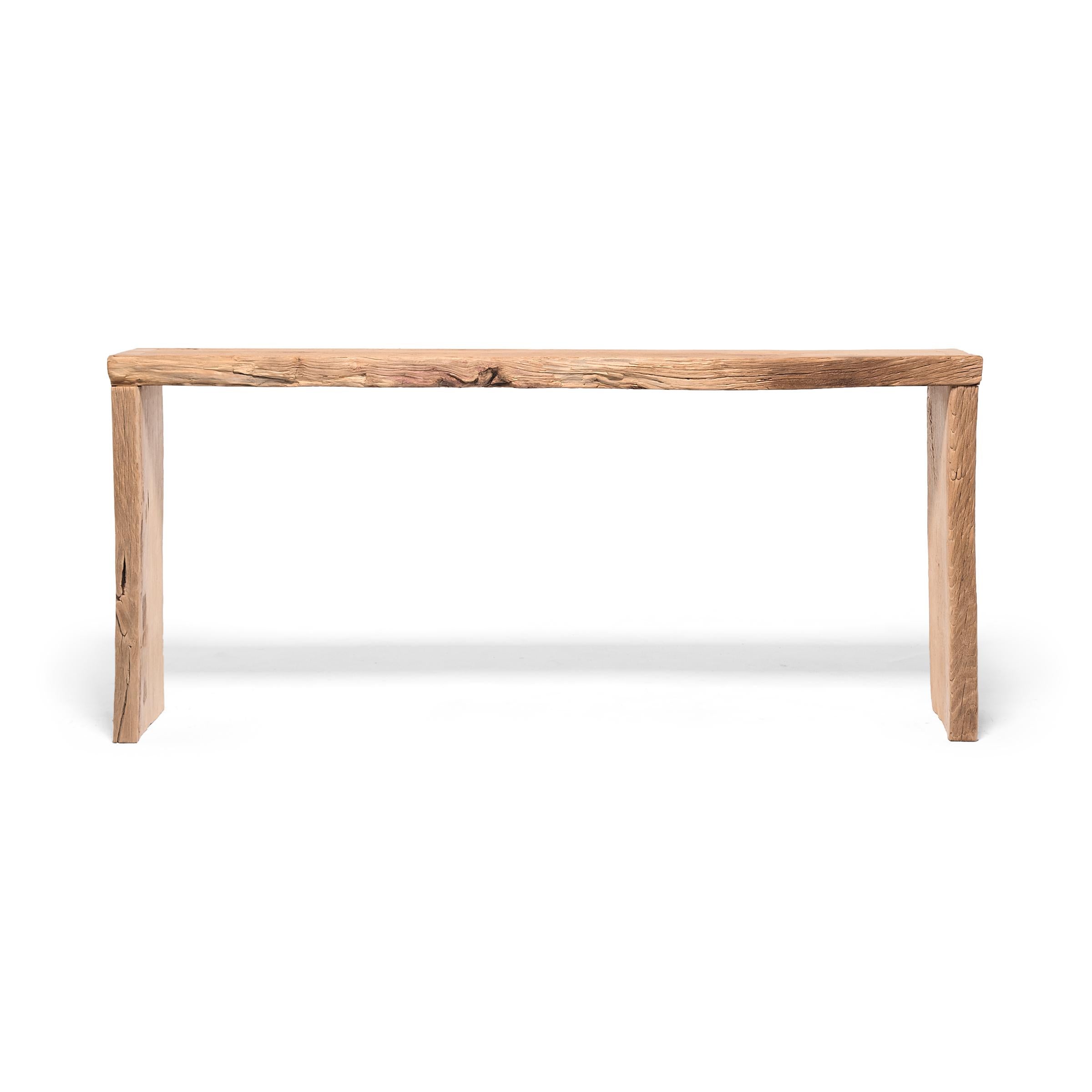Made of wood reclaimed from Qing-dynasty architecture, this contemporary altar table is a celebration of wabi-sabi style. In the spirit of traditional Chinese joinery, the corners are finished with dovetail joints for a modern waterfall design. The