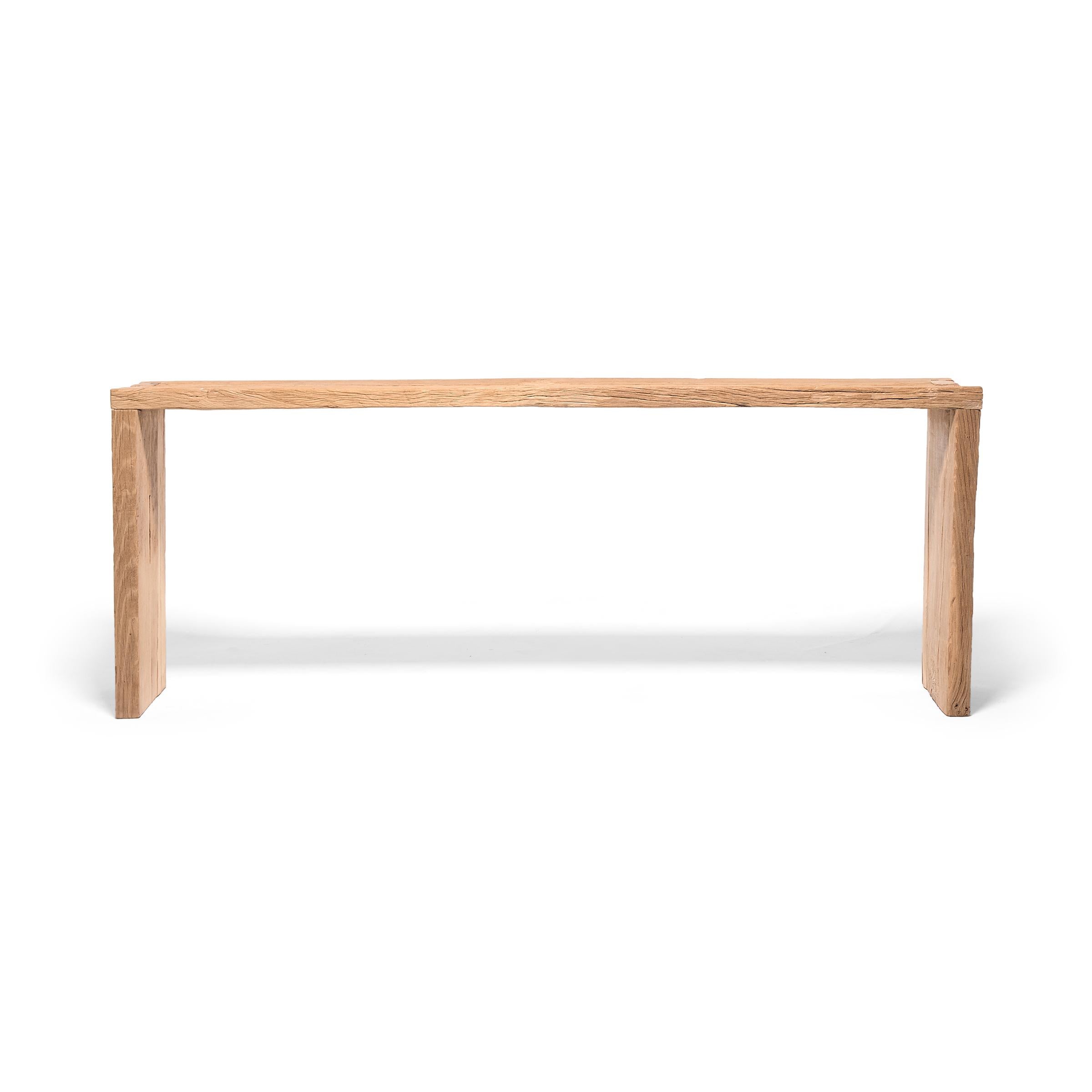 Made of wood reclaimed from Qing-dynasty architecture, this contemporary altar table is a celebration of wabi-sabi style. In the spirit of traditional Chinese joinery, the corners are finished with dovetail joints for a modern waterfall design. The