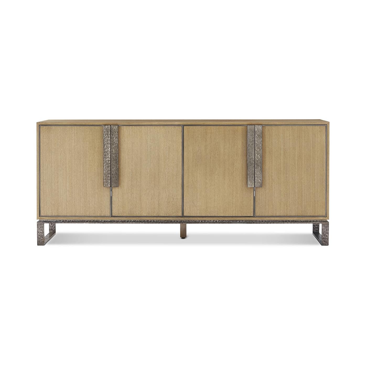Crafted from oak in a blonde finish, its sleek silhouette is accentuated by slender, upright accent lines that add depth and visual intrigue. The bold metal sled base enhances its industrial appeal while maintaining a light and airy