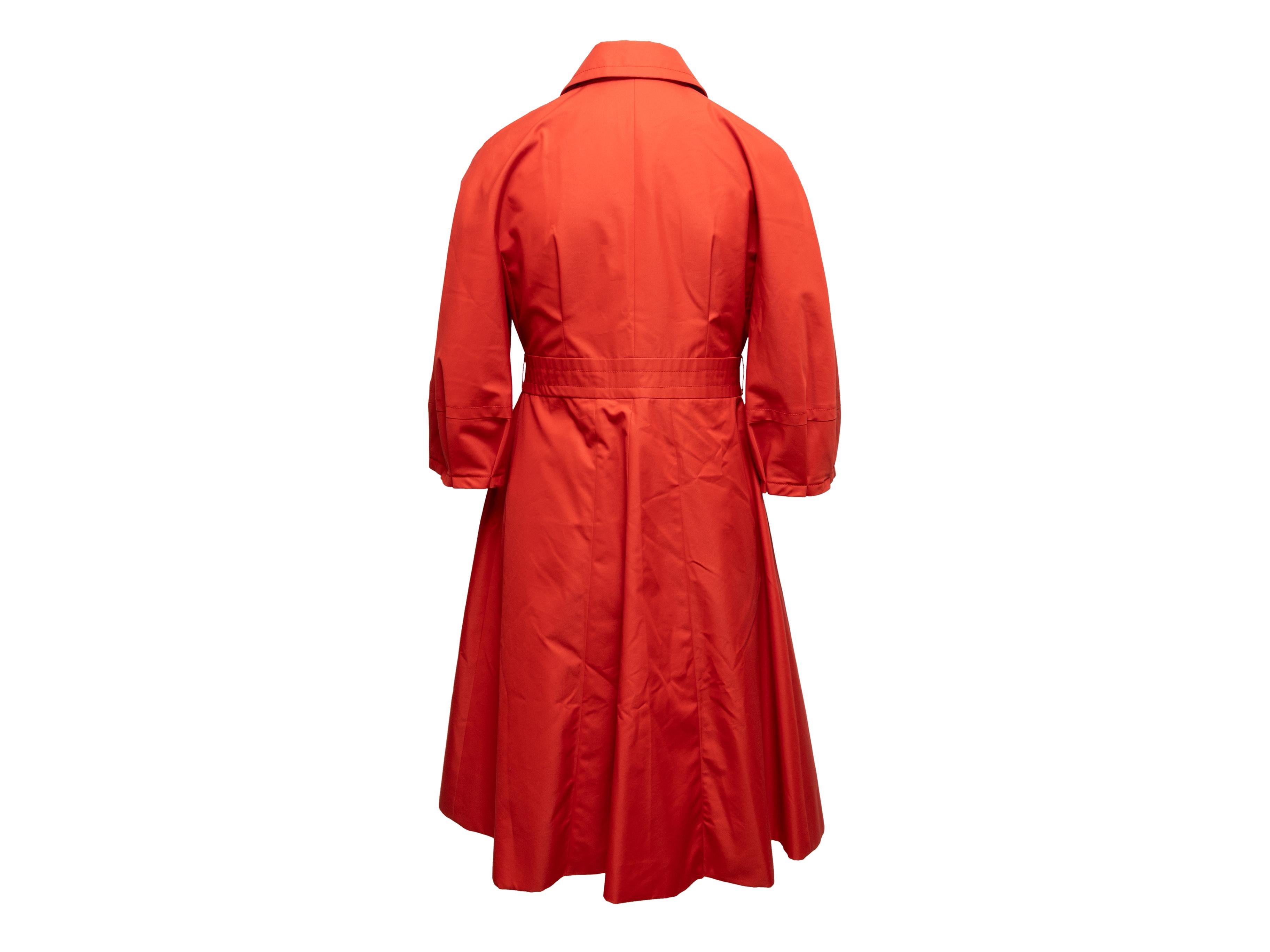 Blood orange three-quarter sleeve trench coat by Gucci. Pointed collar. Dual hip pockets. Button closures at front. Designer size 44. 30