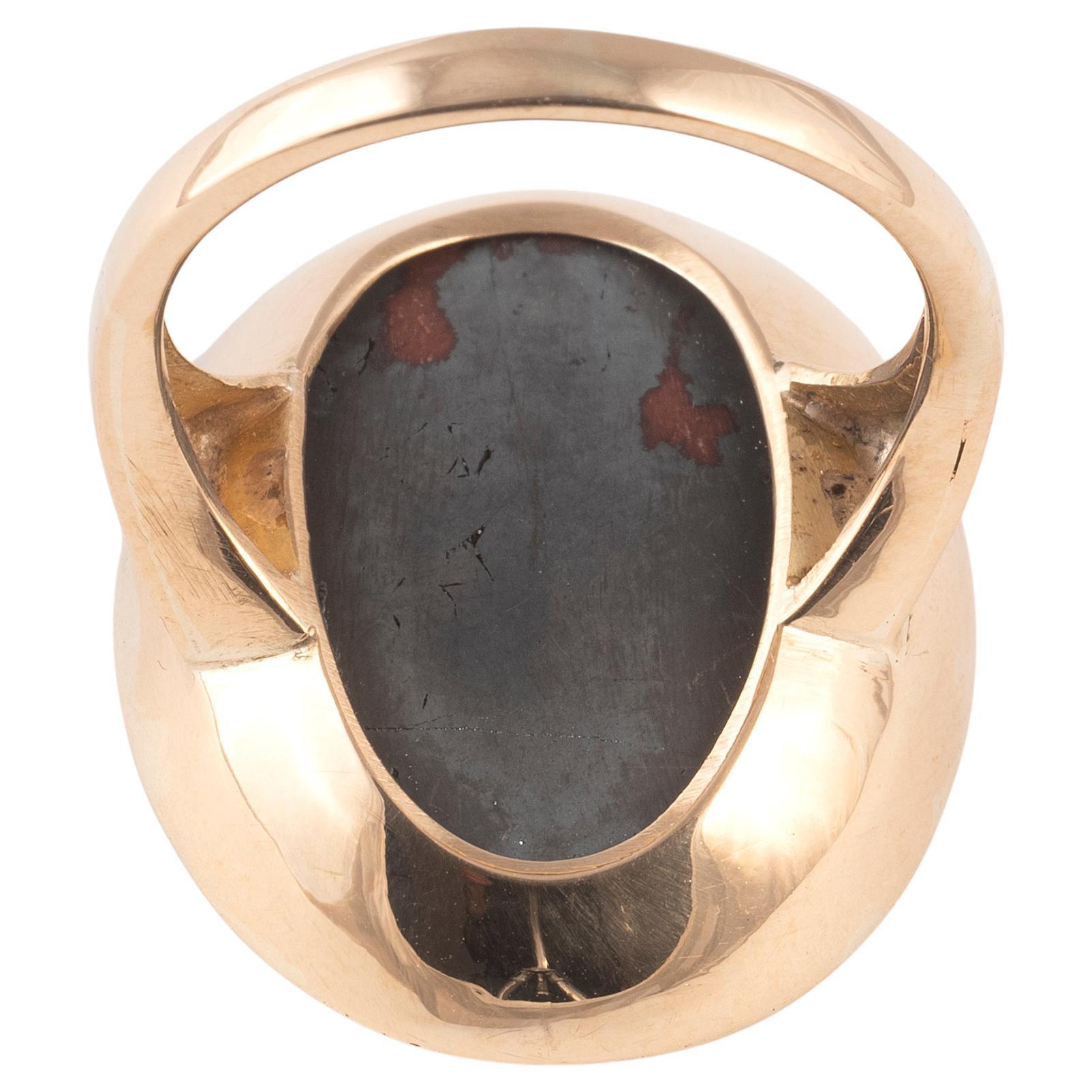 18kt yellow gold ring decorated with a bloodstone intaglio representing Abraxas in the form of a leontocephalic anguipede, holding a palm and a knife.

The intaglio dates to the 3rd century a.C. and figures a rooster-head warrior with snake legs. He