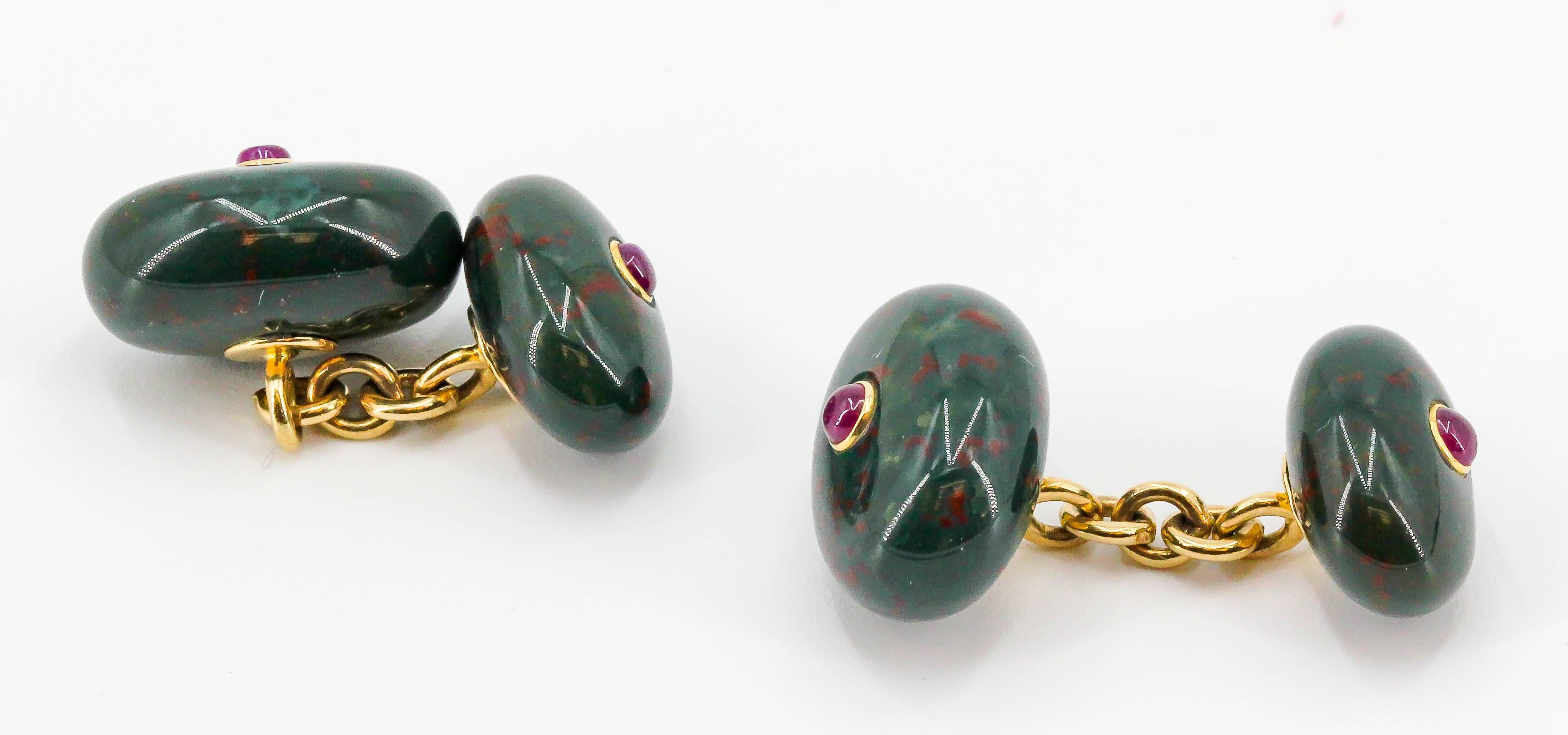 Handsome bloodstone, cabochon ruby and 14k yellow gold cufflinks. They feature rich red cabochon rubies over an oval bloodstone at each end.

Hallmarks: 14k