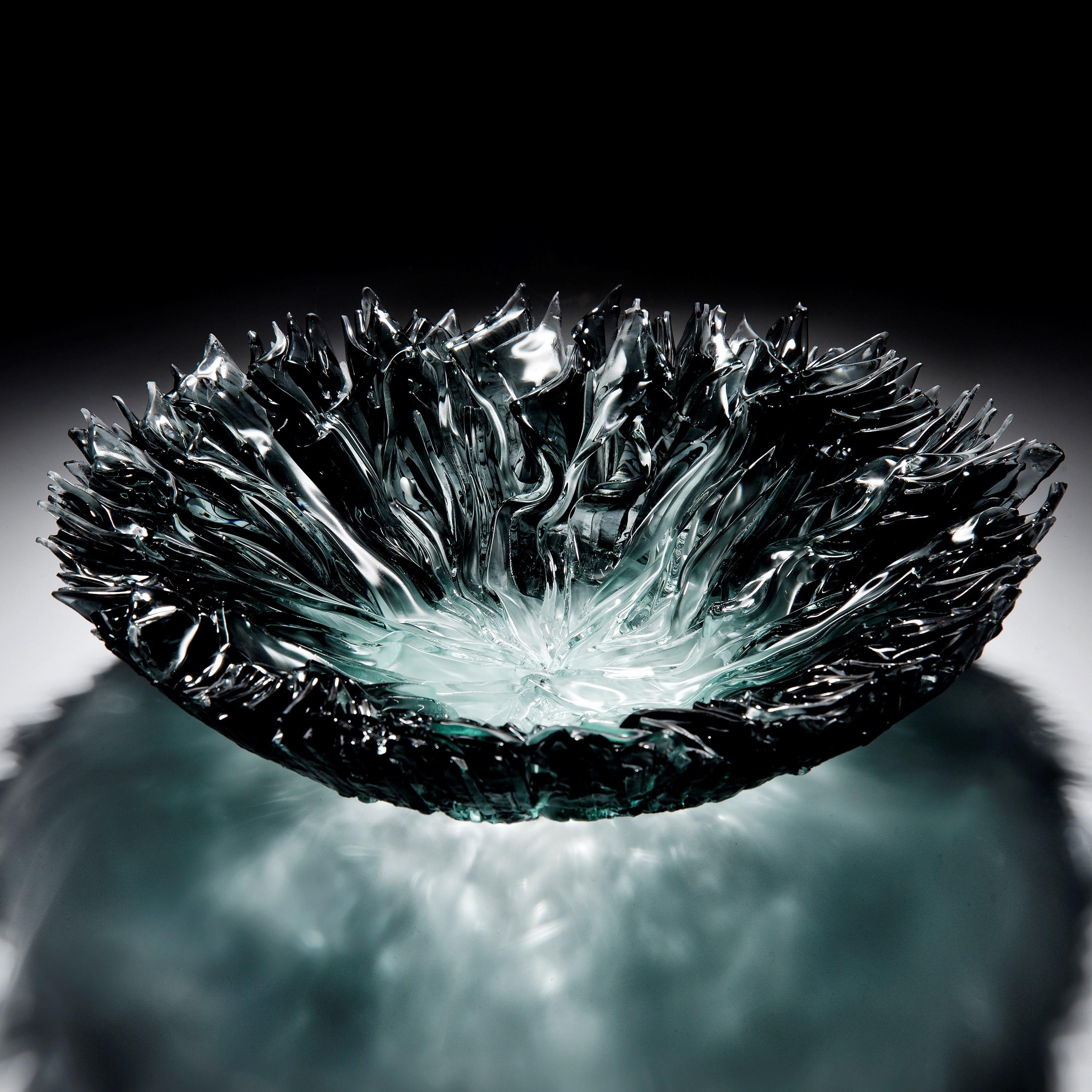 'Bloom bowl in grey' is a unique sculptural centrepiece created by the British artist, Wayne Charmer.

For Wayne Charmer, the fascination of glass is to exploit its translucent and reflective qualities. Inspired by nature, his signature techniques