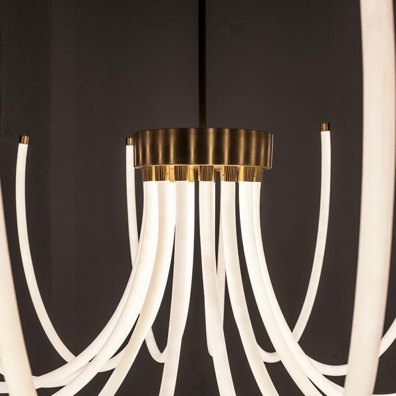 Bloom is a site specific evaluative piece. Each of its 15 arms, made of fabric flexible light, is connected to a central origin that reminds of historical ceiling chandeliers. The arms can be customized in length, position and shape, for better