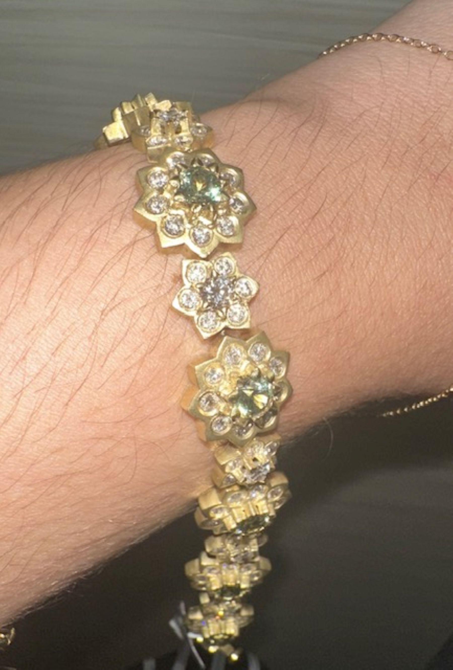 Bloom in Brilliance 
Delicately crafted with floral motifs, this gold bracelet features shimmering white and green demantoid garnets with  diamonds arranged like blooming blossoms. A graceful blend of nature-inspired elegance and fine craftsmanship