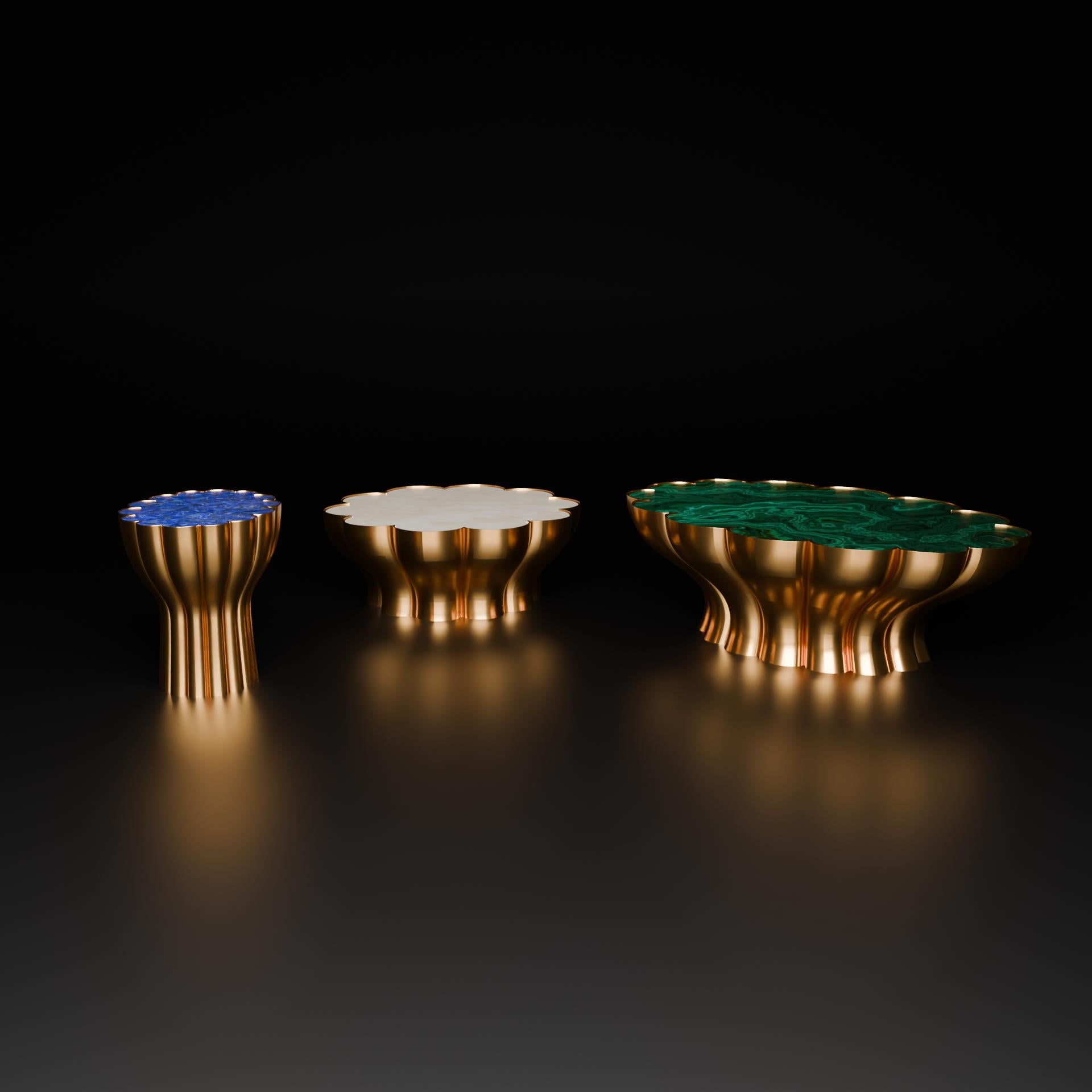 The lines of a flower descend in fluid abstraction in the Bloom Table with rich gold hues. The top is finished in gleaming blue Lapis Lazuli, polished to perfection
Transform your home with a breathtaking piece, the Bloom Table Small. It is
