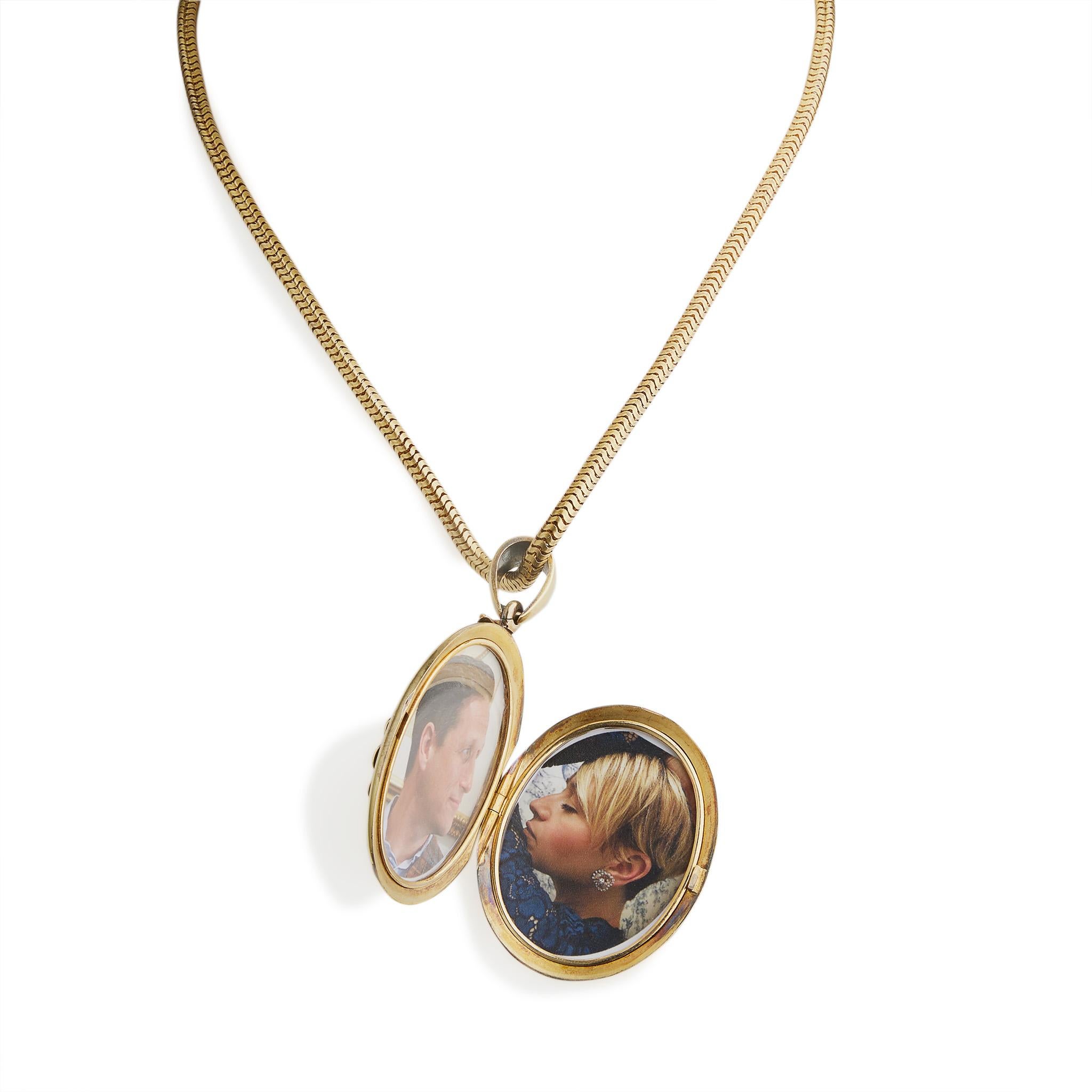 This bloomed 18K gold, pearl and diamond locket necklace dates from the Victorian period. Suspended from a smooth, snake-link chain, the bloomed oval locket centers a split seed pearl and rose-cut diamond floral motif within a stylized leaf and