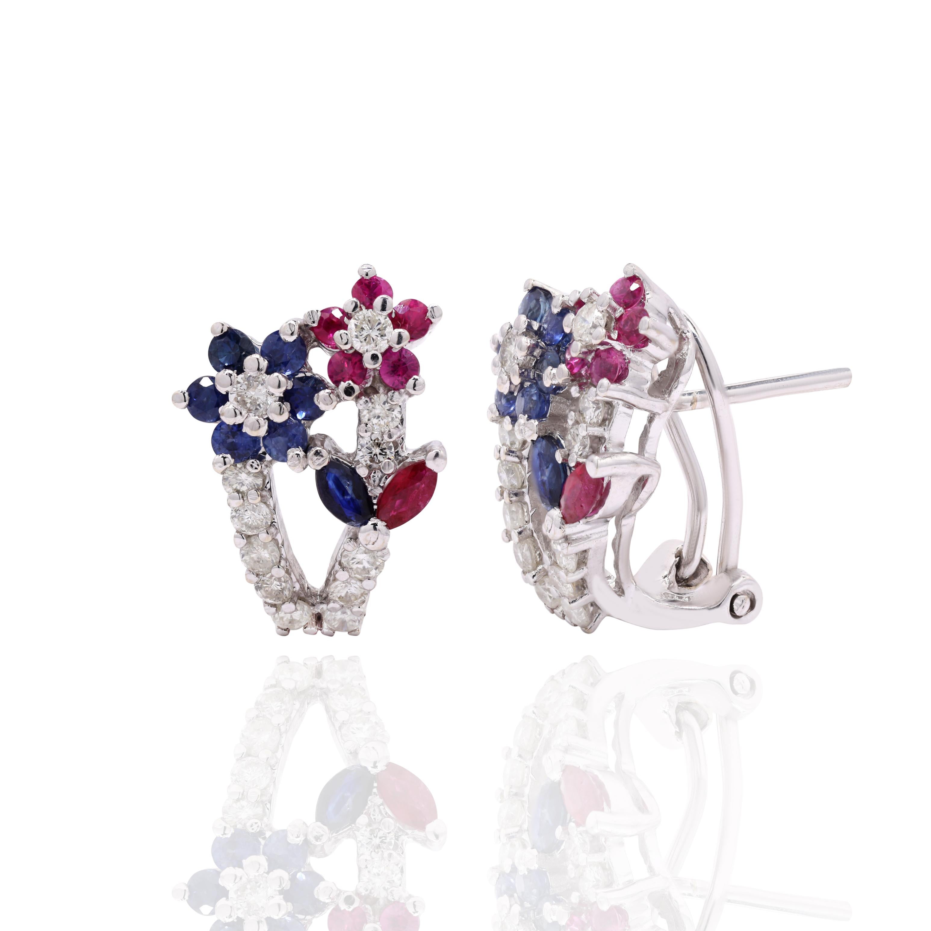 Studs create a subtle beauty while showcasing the colors of the natural precious gemstones and illuminating diamonds making a statement.
Round cut ruby and sapphire studs with diamonds in 18K gold. Embrace your look with these stunning pair of