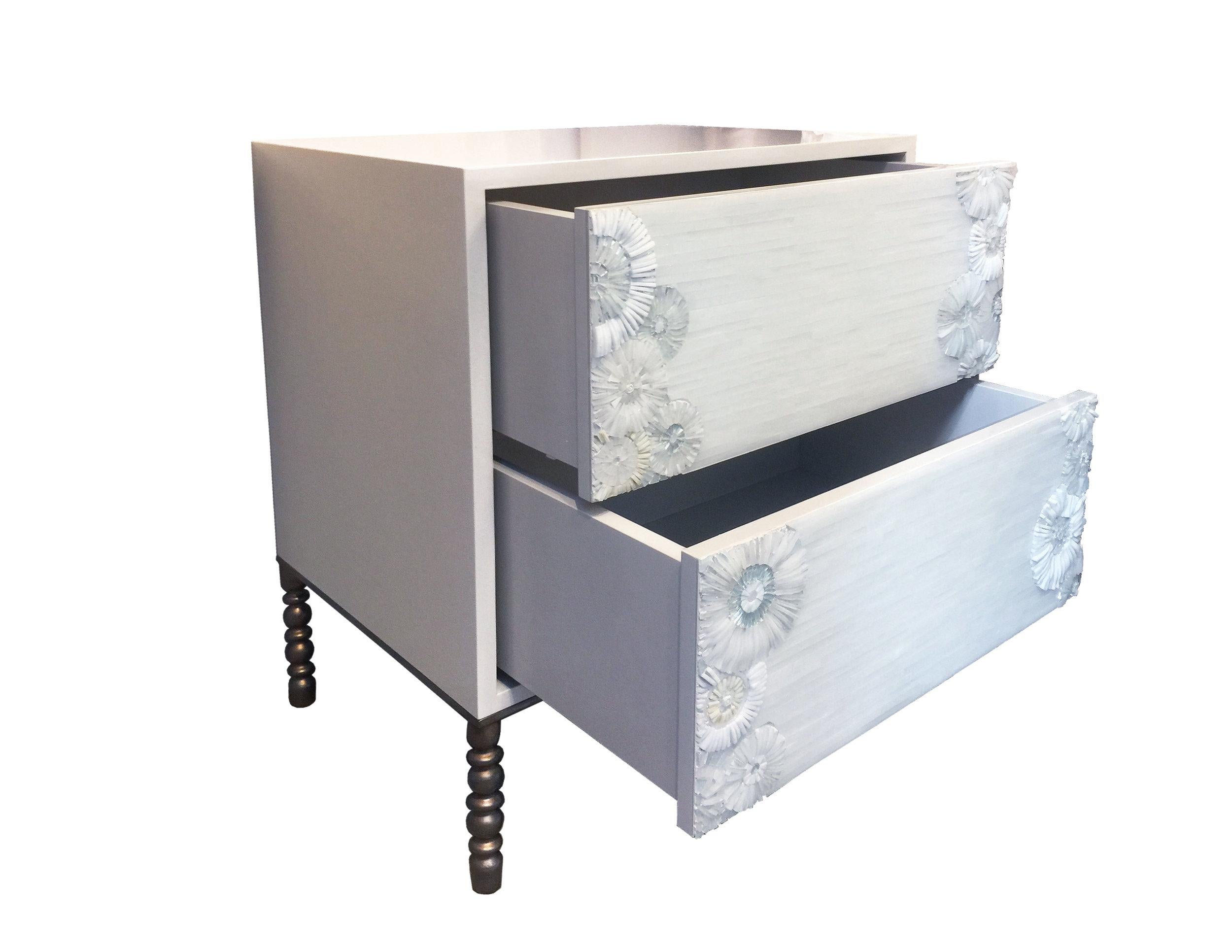 The Blossom 2-drawer nightstand by Ercole Home is a two drawer bed side table with touch latch drawers. The case of this nightstand is covered in a high-gloss Ercole paint finish called Misty Gray lacquer, this color has beautiful warm gray tones