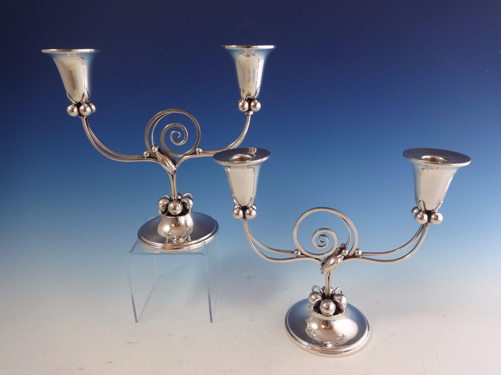 Blossom by Boardman
Modernist sterling silver pair of candelabras made by Boardman of Hartford, CT, circa 1940s. They feature a Danish-modern style with blossoms and 3-D balls. The candelabras each hold two candles. The piece is marked with #1203.