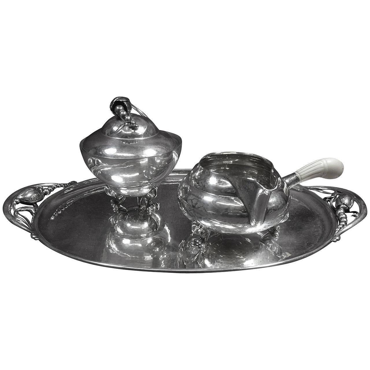 Blossom by Georg Jensen superb blossom by Georg Jensen sterling set includes a sugar bowl, creamer with faux bone (bovine) handle circa 1915, and a tray with date marks circa 1950s. Tray: 14 long, 8 1/4 wide, weighs 19.4 ozt, and marked with #2H.