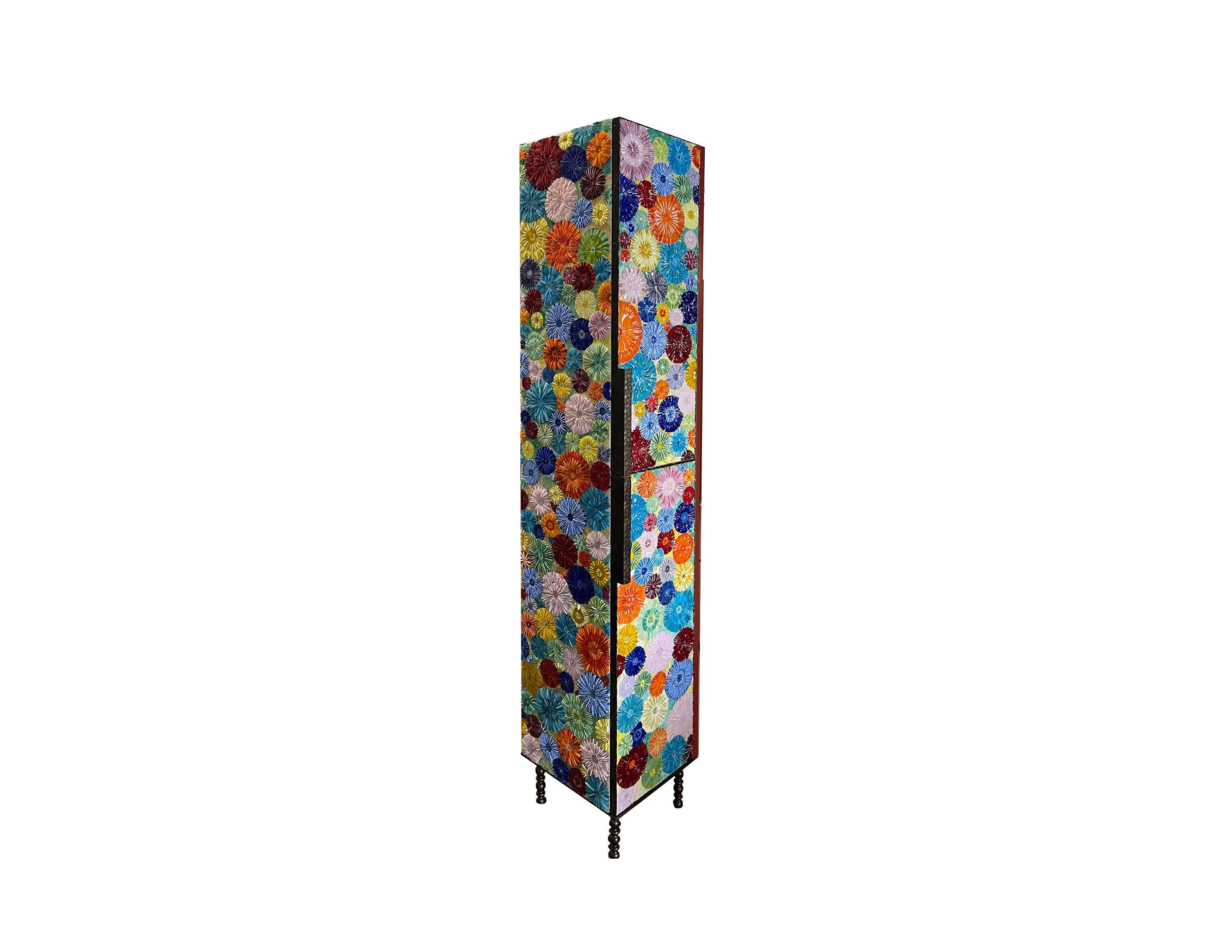 Our custom blossom linen cabinet by Ercole Home is a two-door, six shelf, luxury storage cabinet. Where to begin, the exterior of this piece is covered in our bright, fun, and coloful Ipanema mix inspired by the beaches of Brazil. Each door is