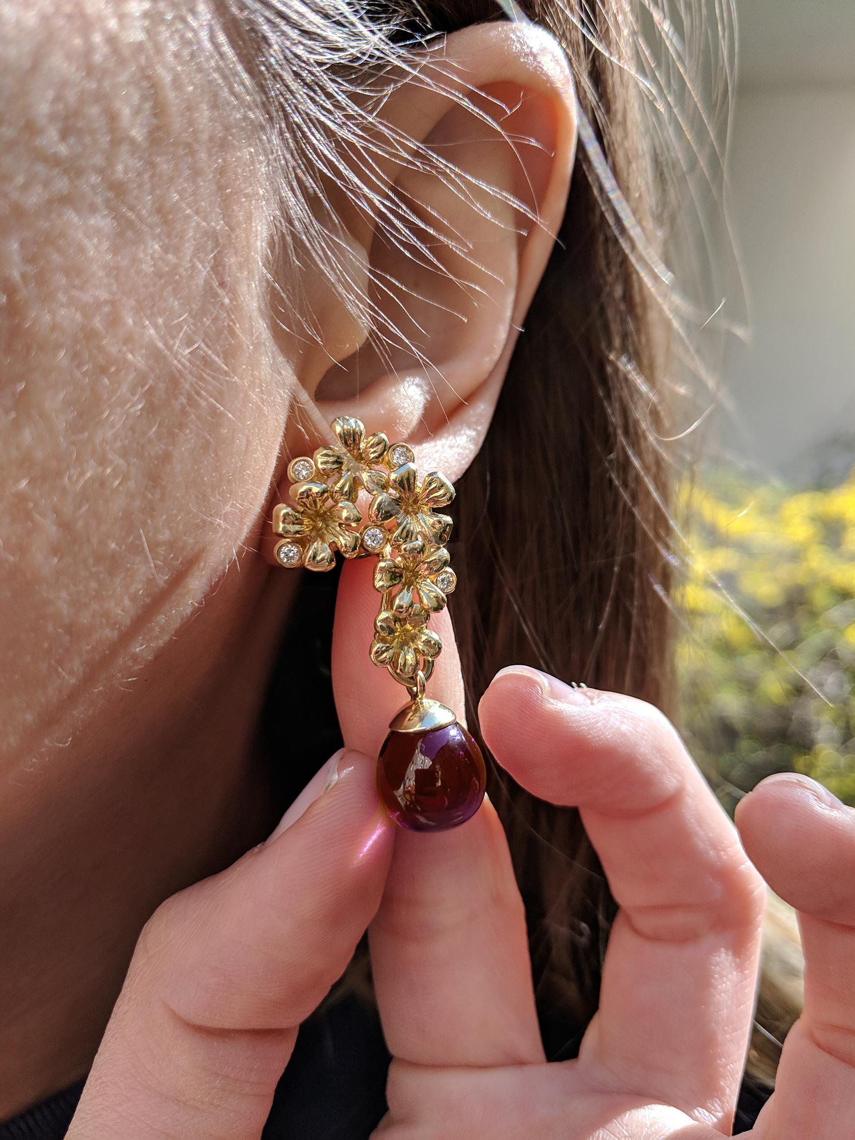 These Plum Blossom cocktail transformer modern earrings with detachable cabochon garnet drops are encrusted with 10 round diamonds. The earrings are made of 18 karat yellow gold and belong to the collection featured in Vogue UA review, influenced by