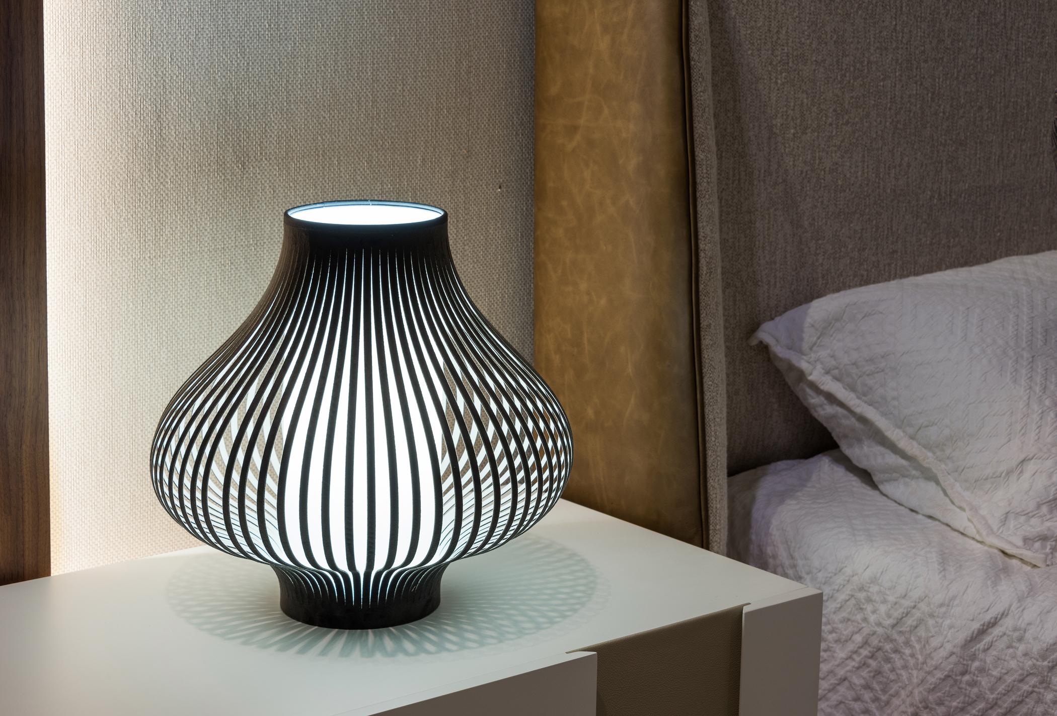 The Blossom is not only a Table Lamp but it’s also a decorative object. When the fixture is on, the light shines through the velvet strips, creating a magical ambient effect. When the lamp is off, its curved lines serve as eye-catching art. Made in