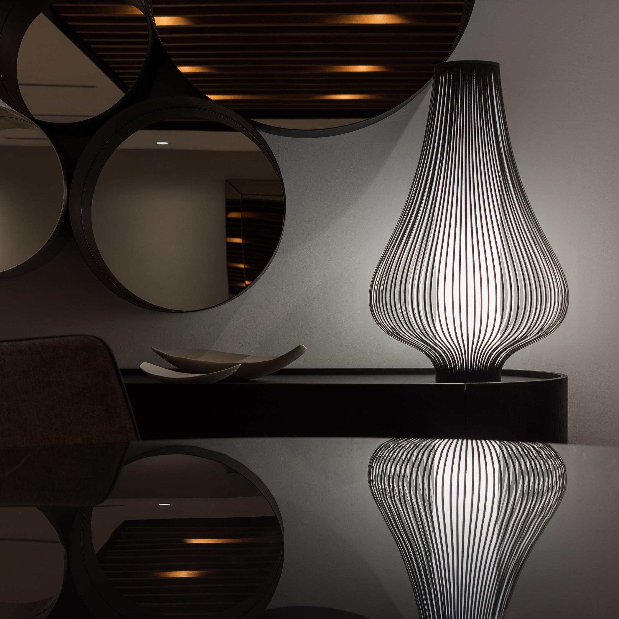 The Blossom is not only a Table Lamp but it’s also a decorative object. When the fixture is on, the light shines through the velvet strips, creating a magical ambient effect. When the lamp is off, its curved lines serve as eye-catching art. Made in