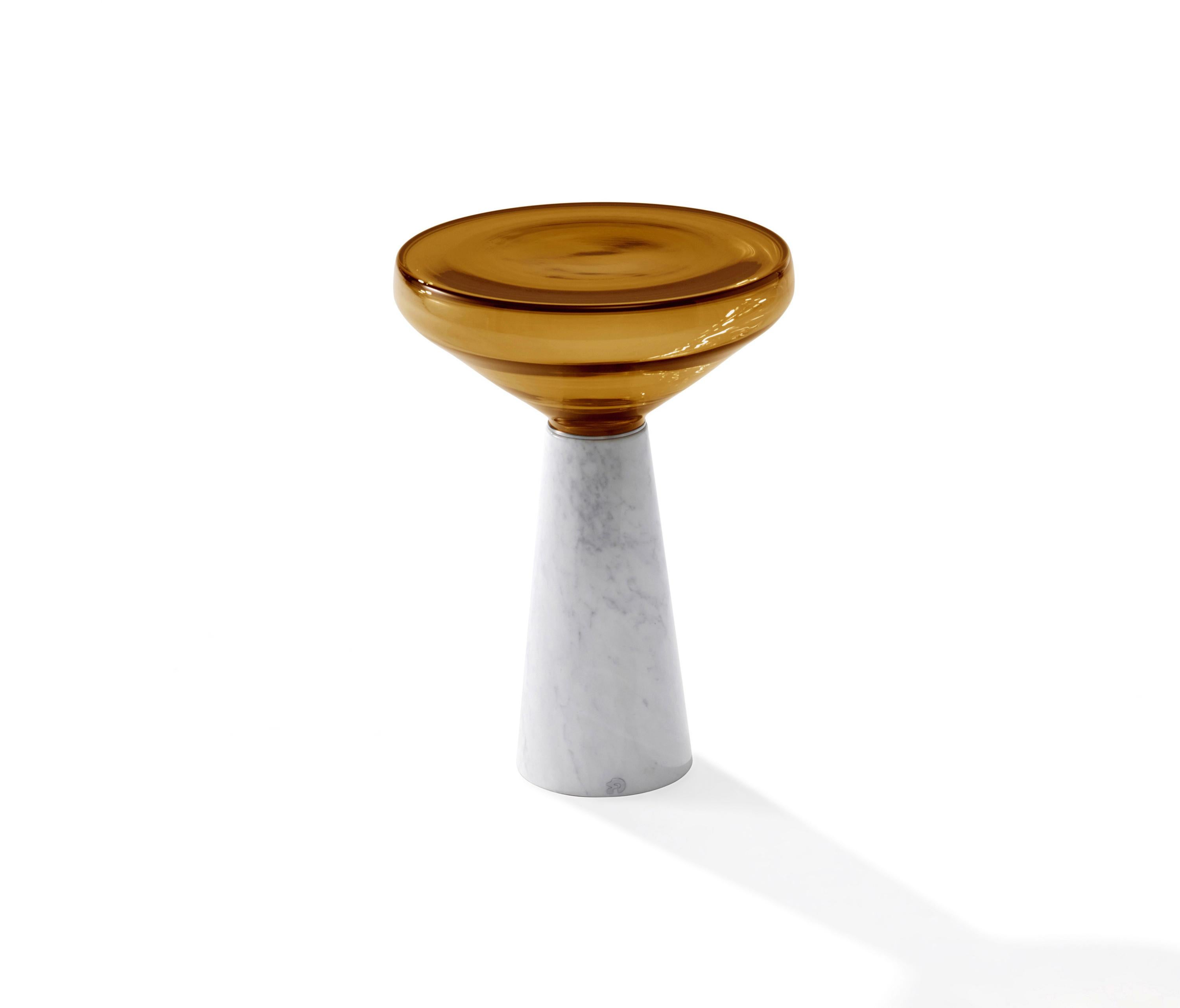 Draenert blow side table designed by Stephan Veit

The Blow side table combines two materials perfectly: stone and glass. The pedestal made of natural stone grounds the table and is the ideal counterpart to the tabletop, made of hand blown glass