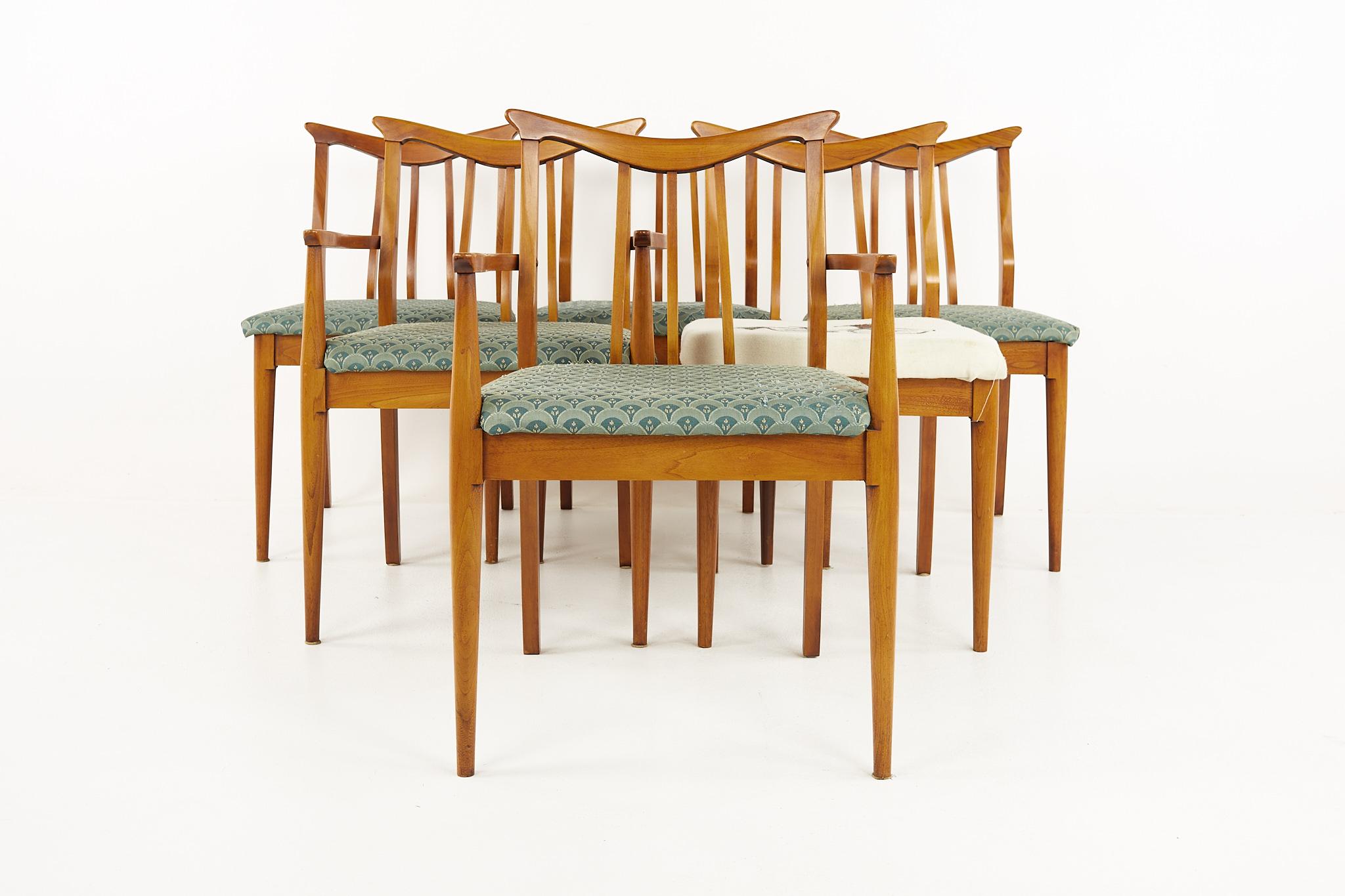 Blowing Rock mid century walnut dining chairs - Set of 6

Each chair measures: 20.5 wide x 19 deep x 34 high, with a seat height of 19 inches and arm height of 25.5 inches; the captain's chair measures 23 inches wide and 20 inches deep

All