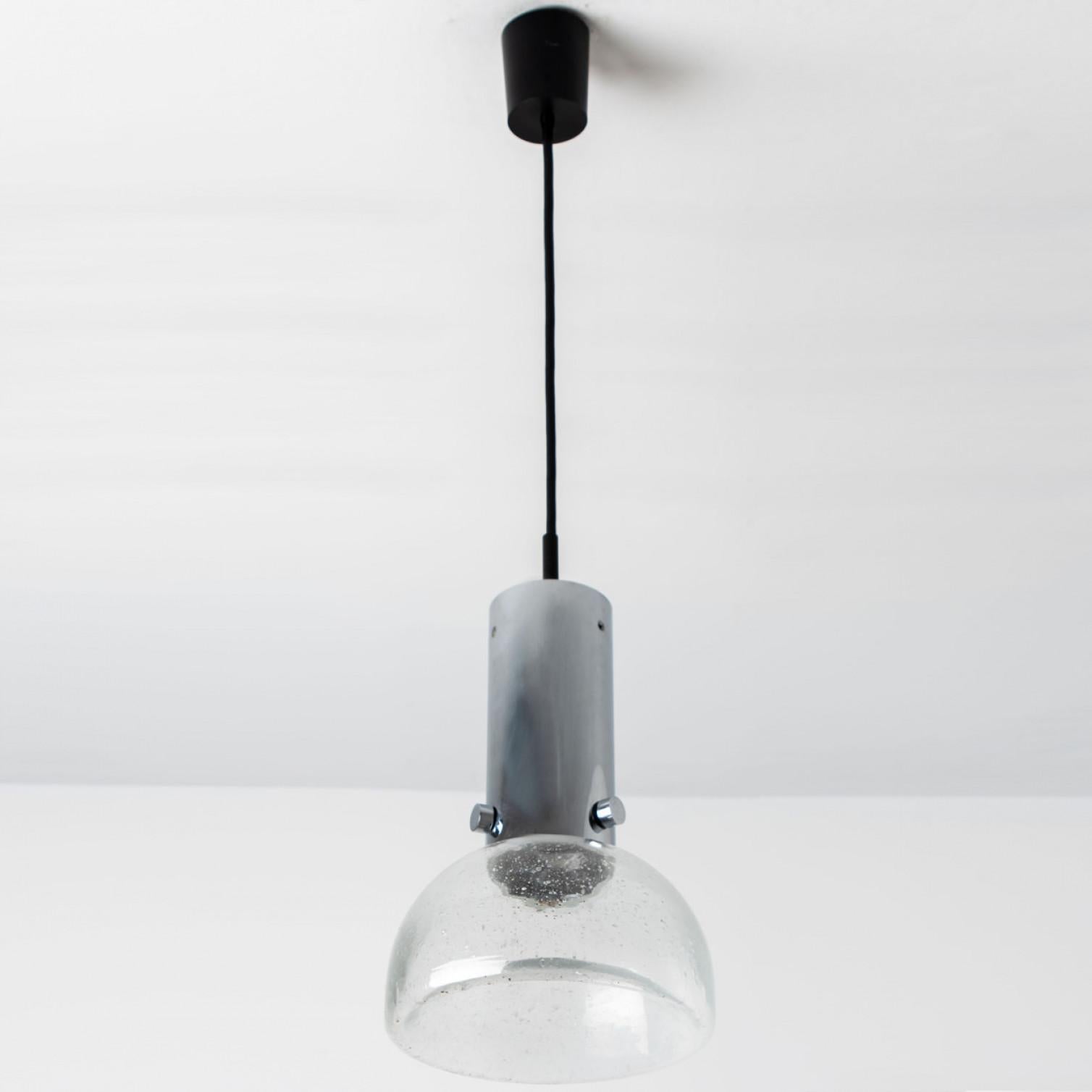 One of the three original 1970s tubular lights produced by Staff Leuchten, Germany.
Heavy quality glass lights with hand blown shades on a chrome pendant. All original.
This item is in excellent vintage condition with very slight traces of