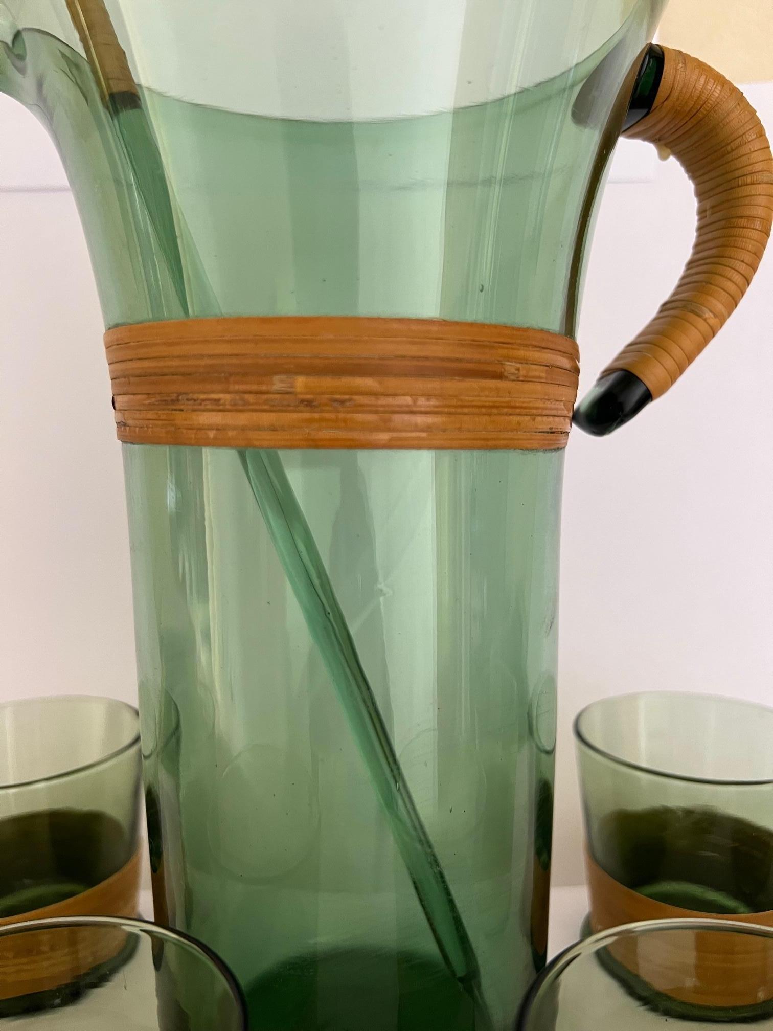 Vintage blown green glass cocktail drink set wrapped in rattan. The set includes seven pieces, a pitcher, six glasses and a stirrer stick.


Measurements:
Pitcher-9.38 tall x 7 across handle
Glasses- 2.58 tall x 2.58 wide at mouth
Stirrer-