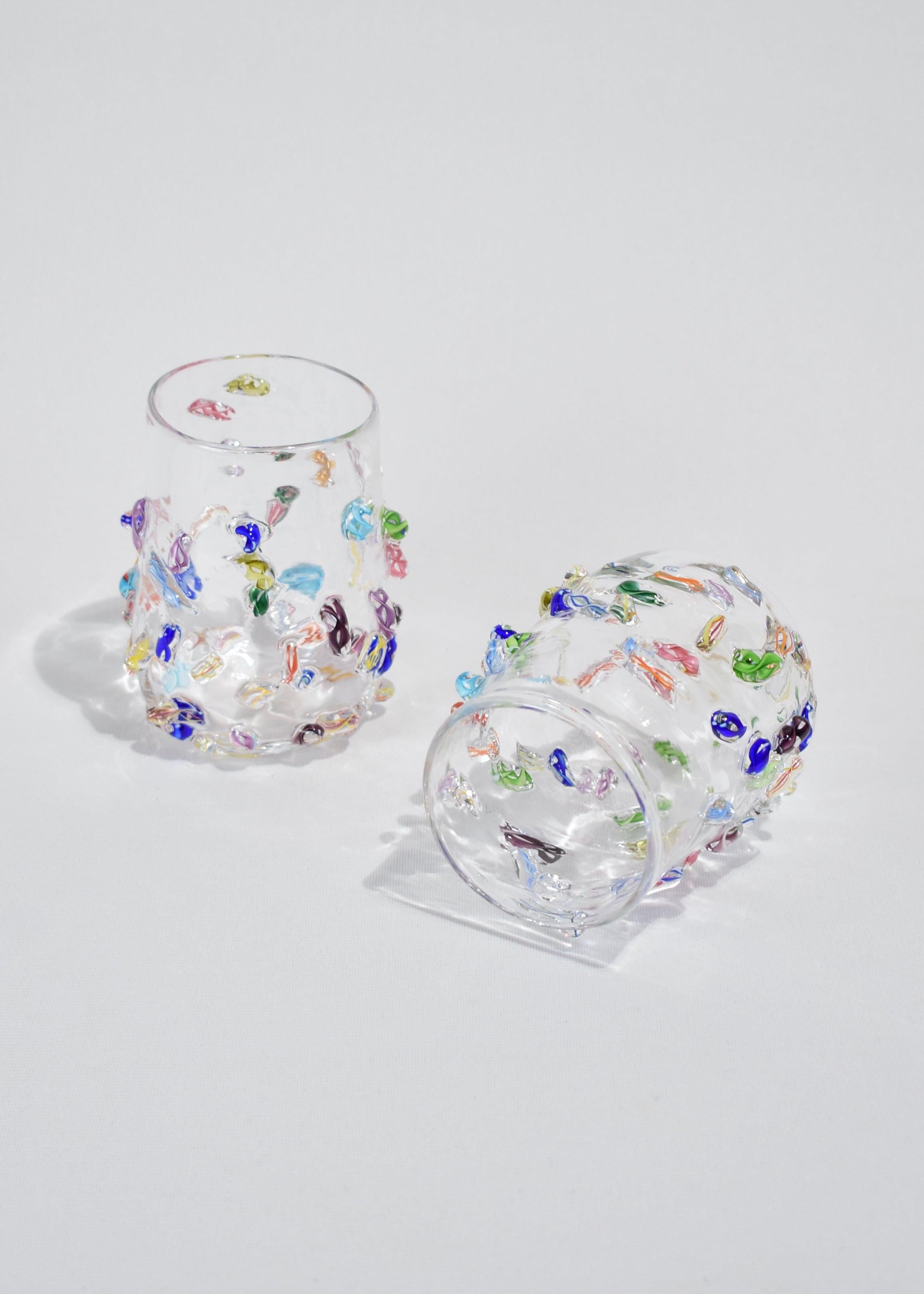 Blown glass tumbler set of two with applied cane decoration. Handmade in USA by Lisa Stover. Exclusive to Casa Shop.

Please note: Due to the handmade nature of these tumblers, subtle variations in form and finish are to be expected. Hand wash
