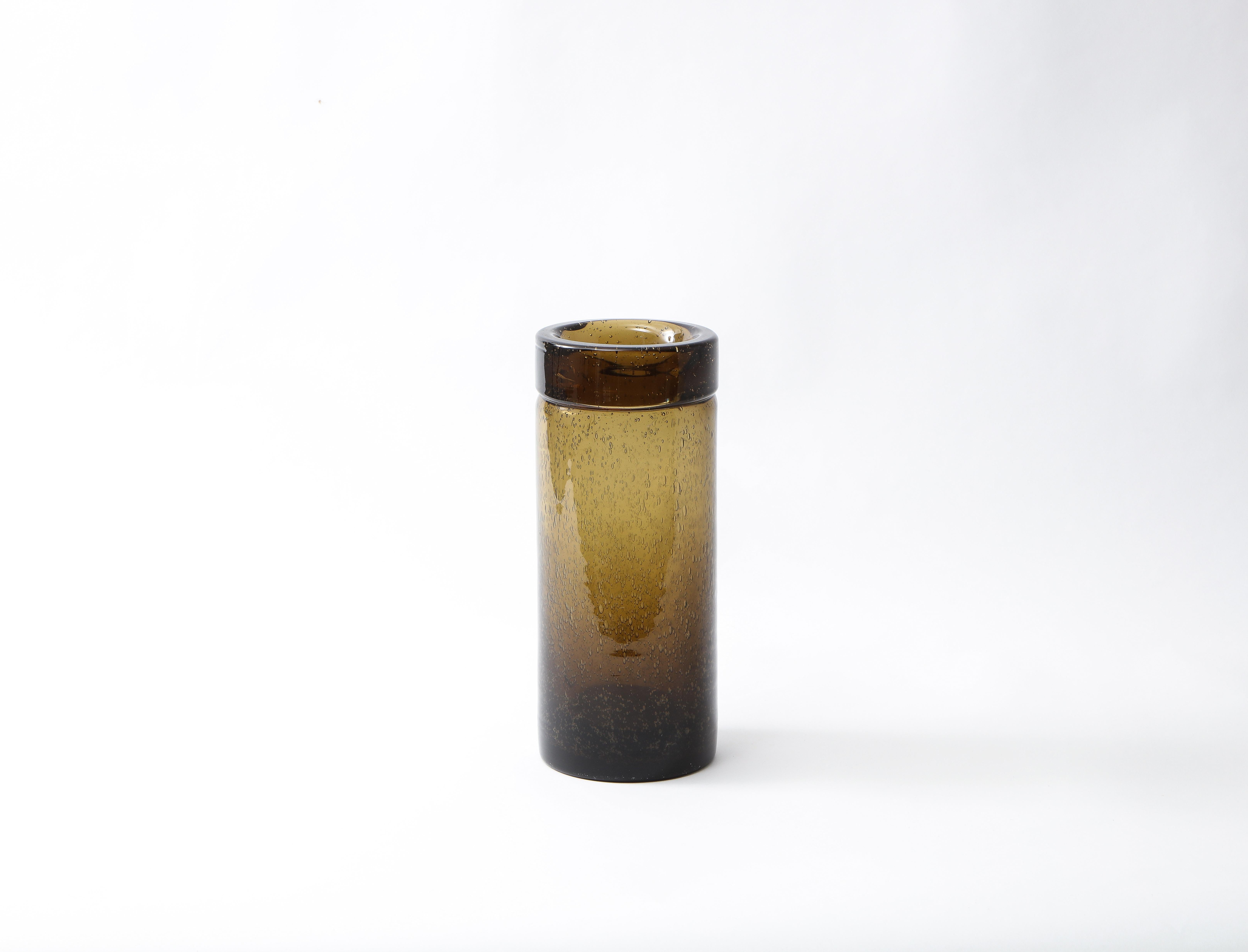 Narrow translucent blown glass vase from the Verrerie de Bendor, on the Island of Bendor in the South of France. The light olive green color darkens towards in the base with a deep ombre.