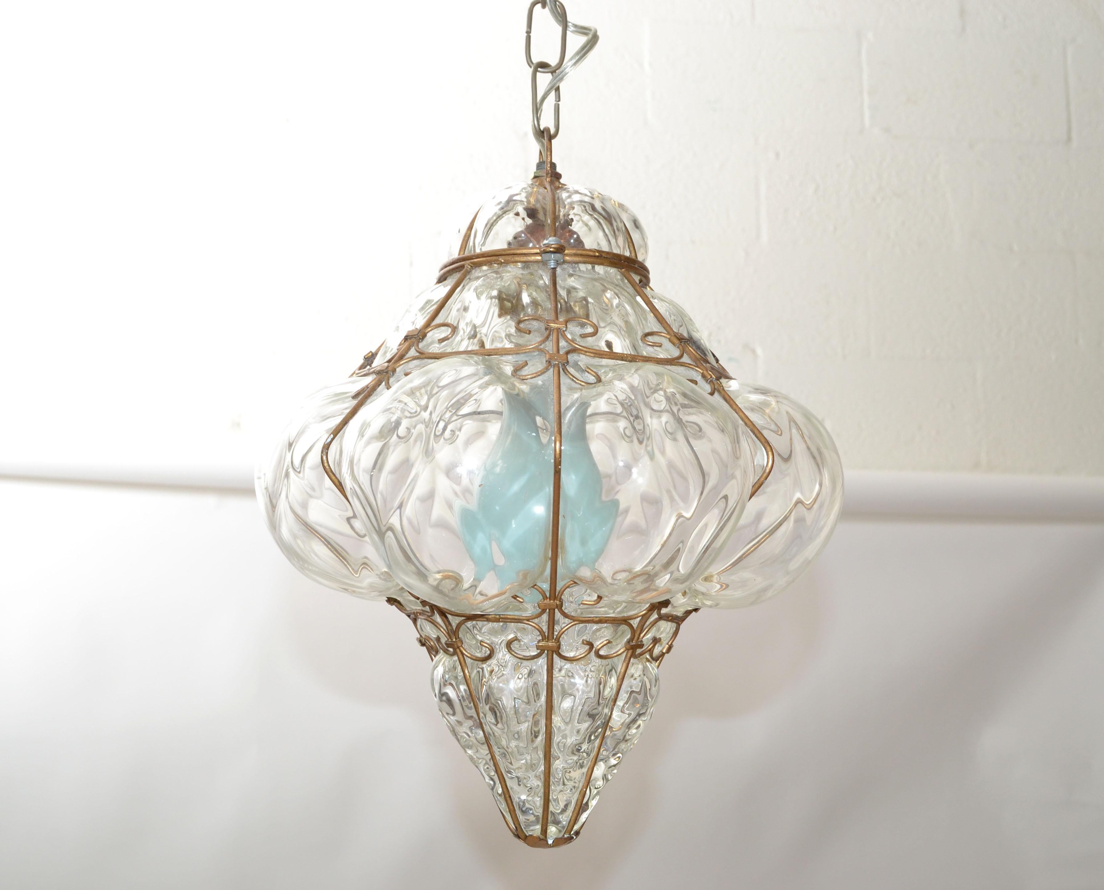 Blown Murano Glass caged pendant lamp, Bubble Glass Lantern made in Italy in the late 1940.
Created to project a patterned light shadow in a smaller transitional space. 
Gold Finished frame and canopy covered with some wear.
Wired for the US,