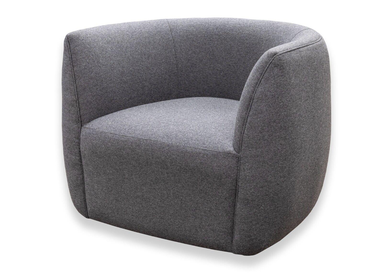 A Blu Dot Council contemporary modern swivel lounge chair in gabro grey. A gorgeous accent chair featuring a very chic, modern design. This wonderfully comfortable lounge chair features a soft wool blend upholstery, a wooden frame, and a bottom