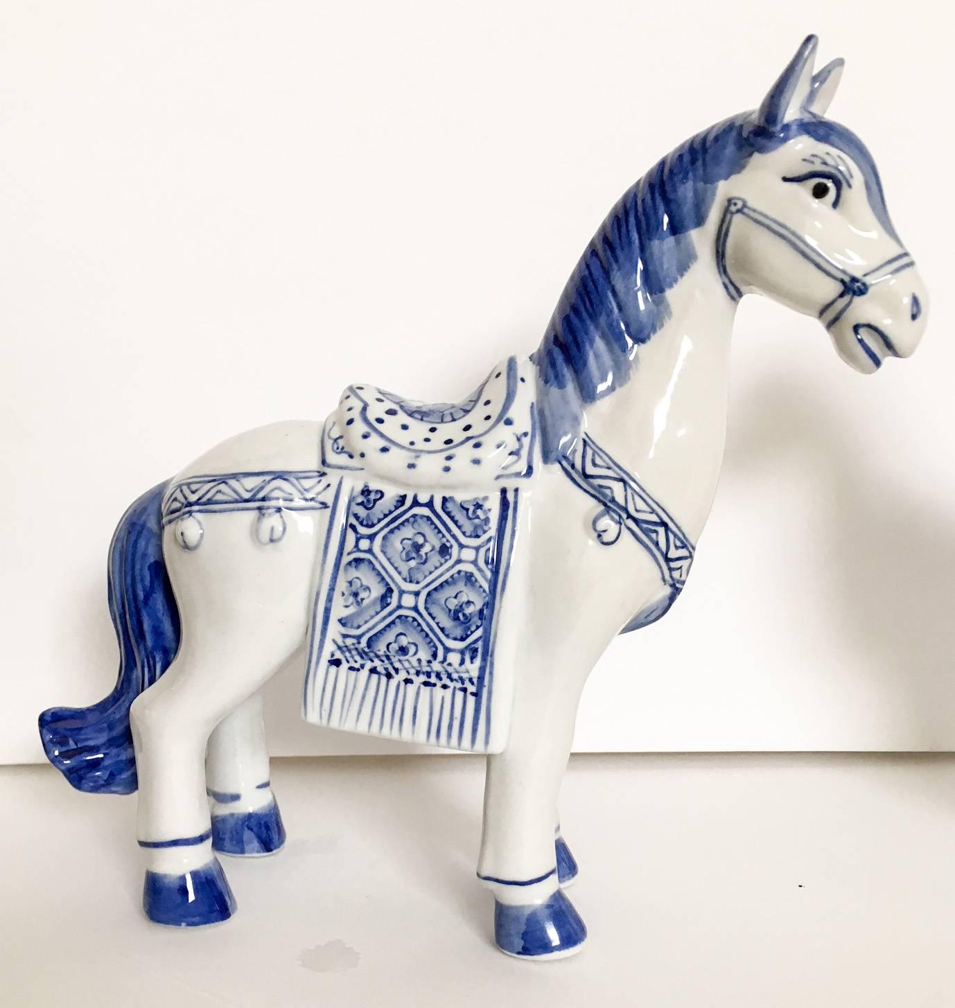 Delightful pair of white ceramic horse figures decorated with blue. Each measures 8.5