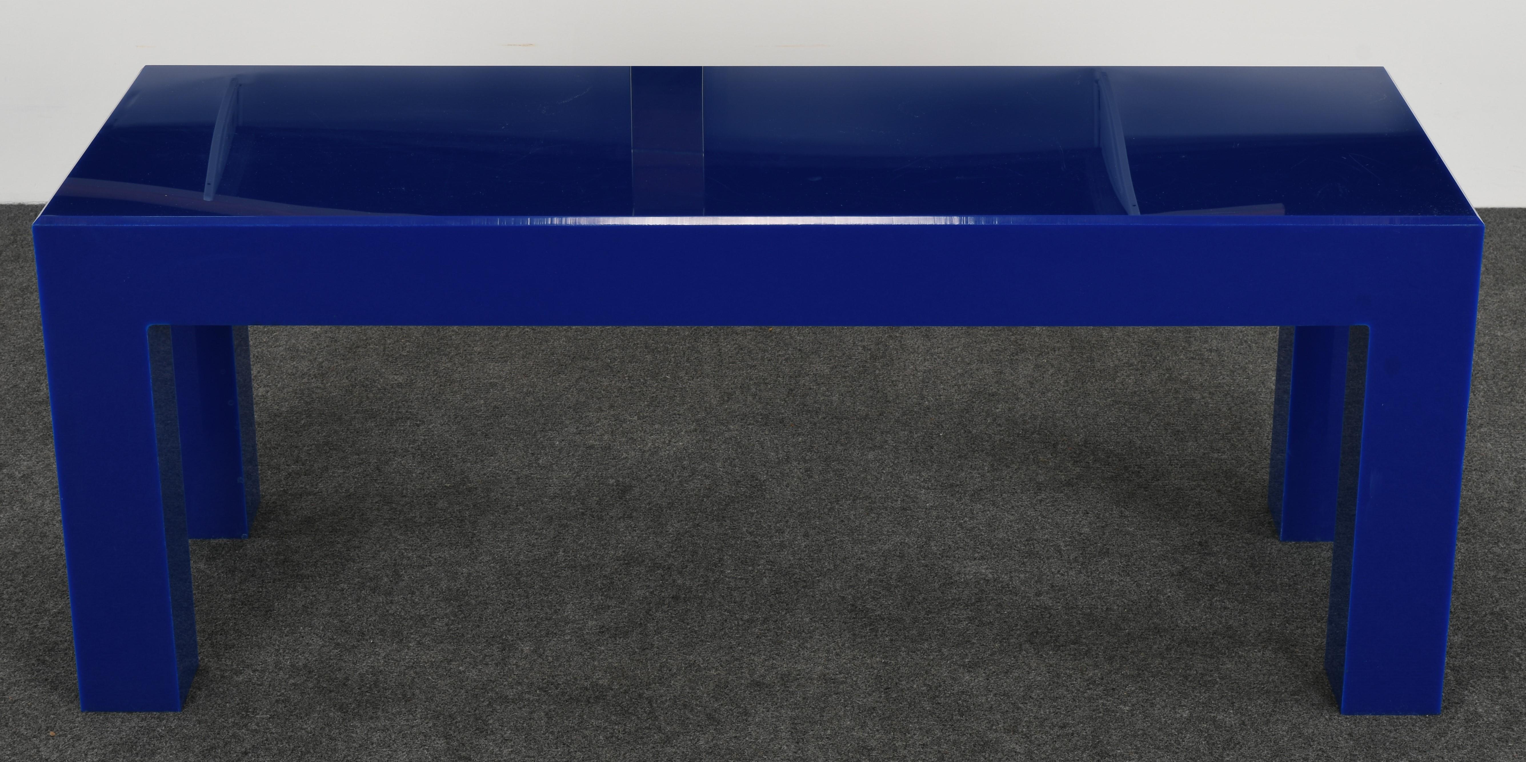 A Yves Klein blue acrylic or Lucite coffee table. This cocktail table would make a stunning focal point for a room. The table is structurally sound with age-appropriate wear. There are fine scratches and a few scuffs throughout, as shown in