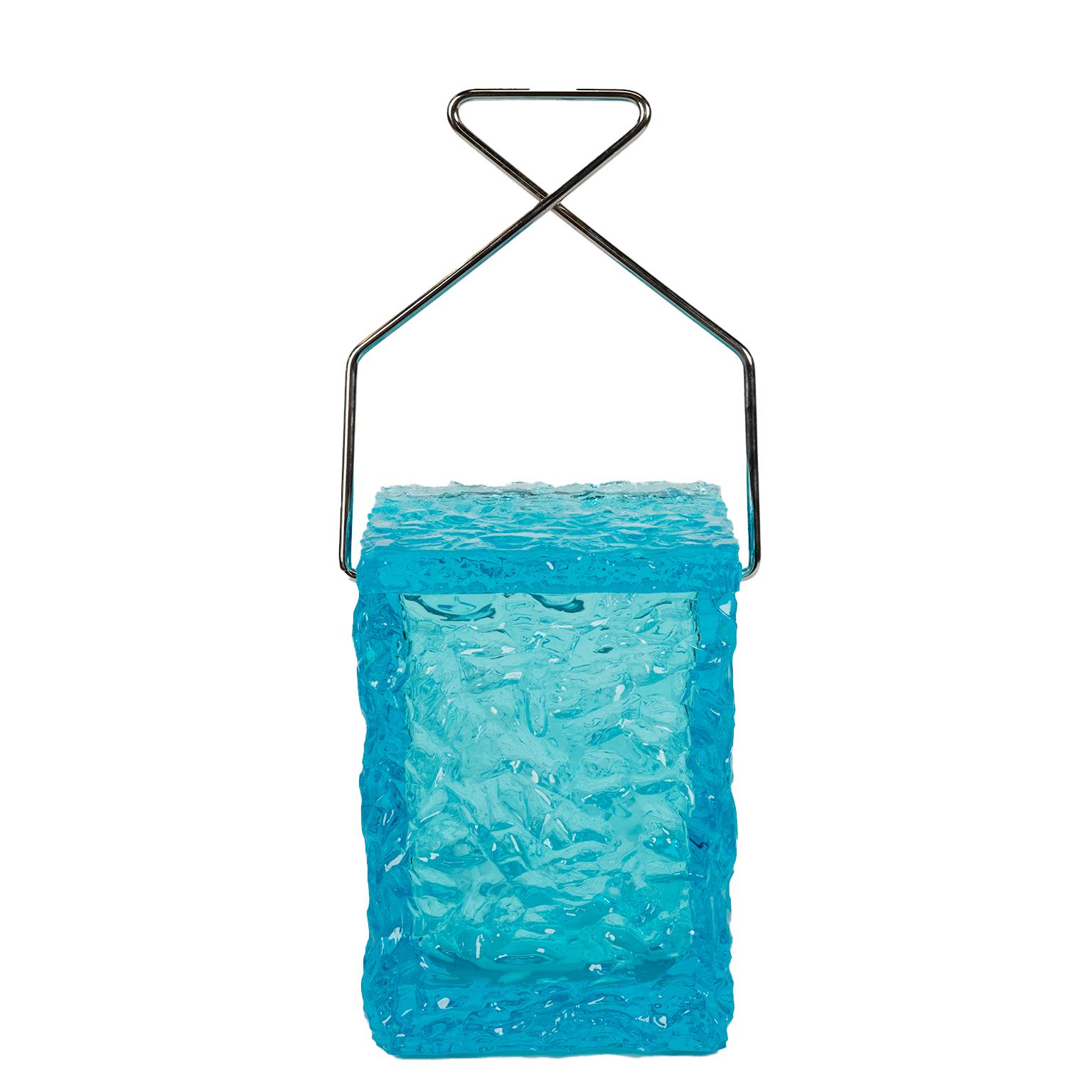 This is a rare vibrant turquoise blue “ice cube “ ice bucket with textured details and a handle in the shape of a ice pick. If you love the colour blue, entertaining and something a little different then this is a great bar accessory for all