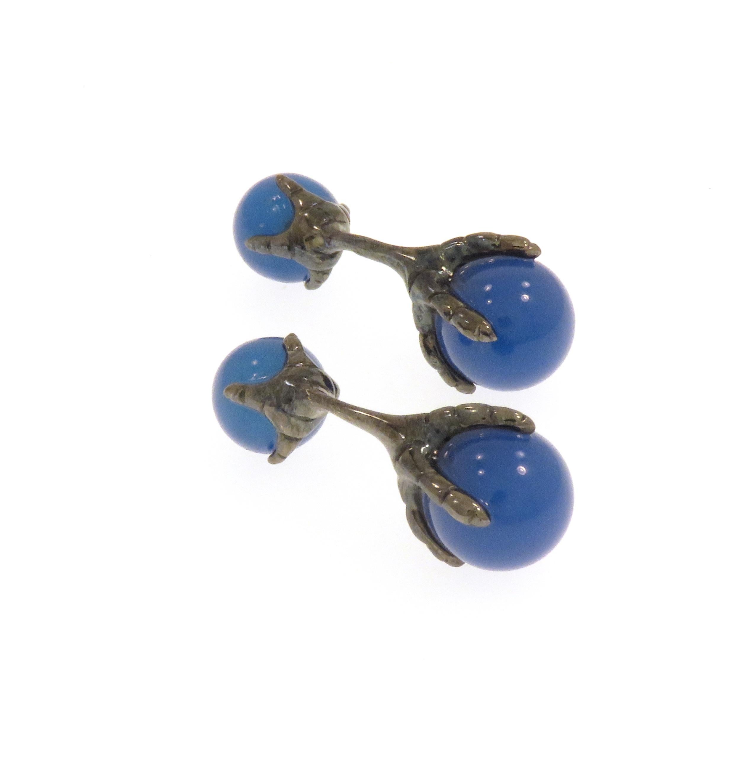 Beautiful cufflinks crafted in 9k white gold black rhodium plating featuring eagle talons grabbing blue agate beads. The size of the bigger beads is 12 millimeters / 0.472 inches and of the smaller ones is 10 millimeters / 0.393 inches.  These