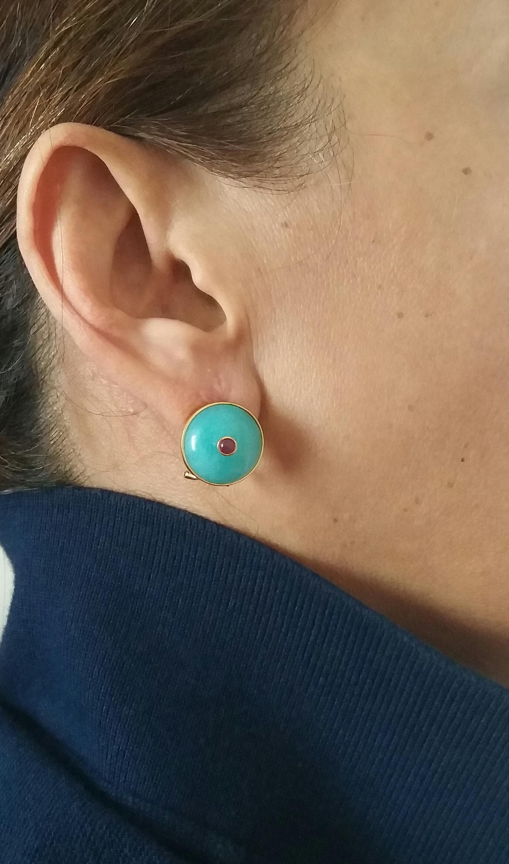 Simple elegant clip on earrings with round plain Blue Amazonite cabochons of 16 mm in diameter set in 14 Kt yellow gold  with a round Ruby cabochons of 4 mm in diameter,also set in 14 Kt yellow gold.
In 1978 our workshop started in Italy to make