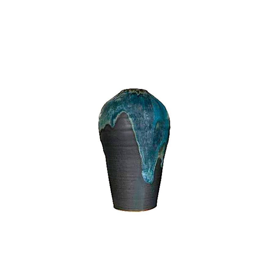 Contemporary American ceramicist Peter Speliopoulos stoneware vase.
The matte blue glaze, paired with an agate glaze, react to create pieces with a mineral feeling, just unearthed.
Matte charcoal base.
One of many pieces from a series of