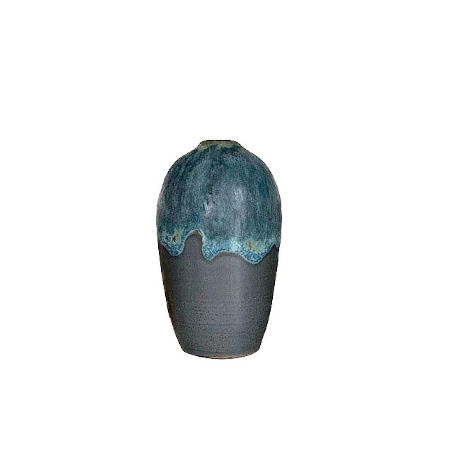 American ceramicist Peter Speliopoulos stoneware vase.
The matte blue glaze, paired with an agate glaze, react to create pieces with a mineral feeling, just unearthed.
Matte charcoal base.
One of many pieces from a series of work
This piece sits