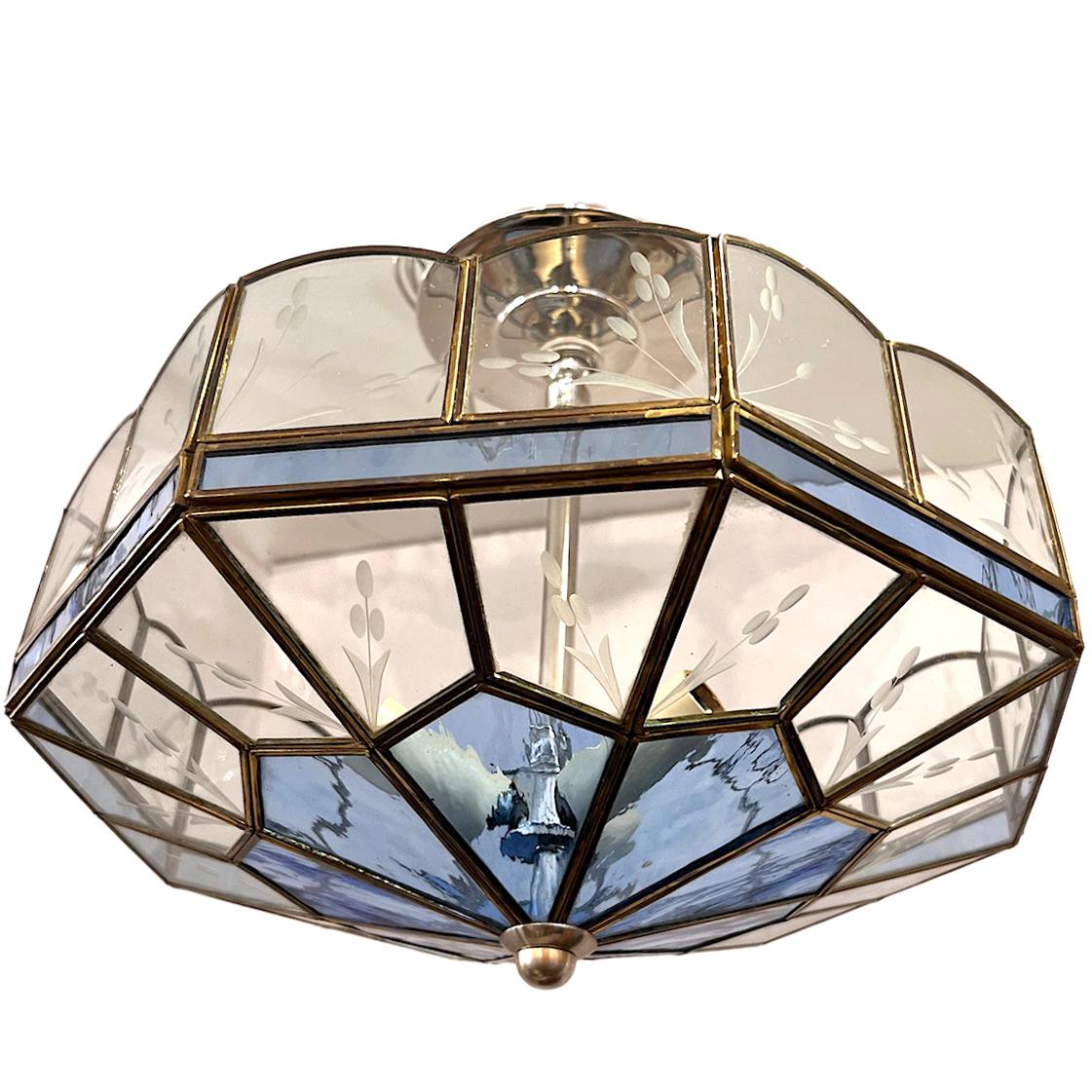 A circa 1950's English leaded glass light fixture with 3 interior candelabra lights.

Measurements:
drop: 11