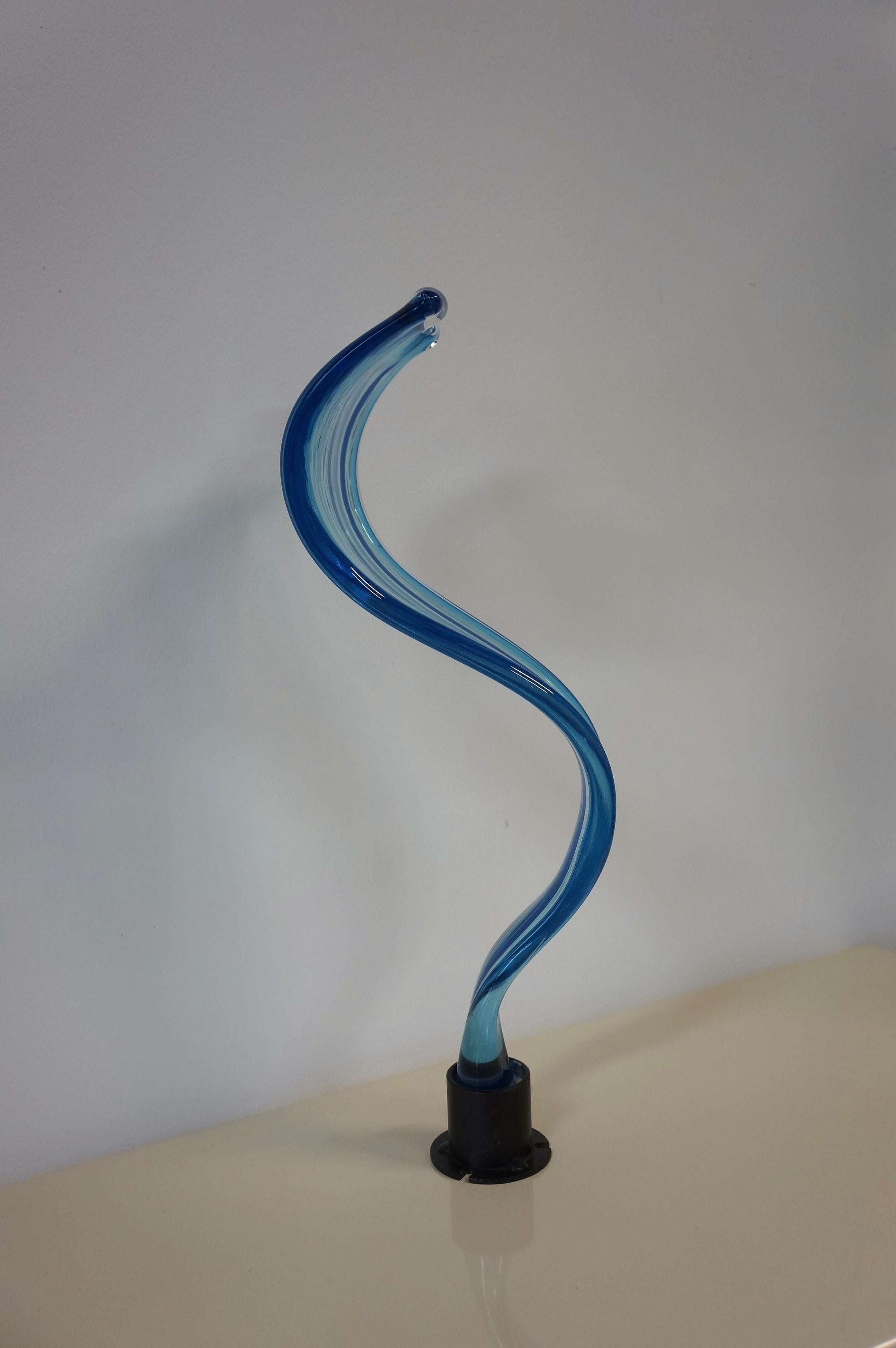 Abstract Art Glass wavy and swirl sculpture attributed to Murano glass. Made in Italy in the 1970s, this stunning sculpture is finished in clear and blue art glass. It’s made in the shape of a wave. The top of the sculpture begins as wider and