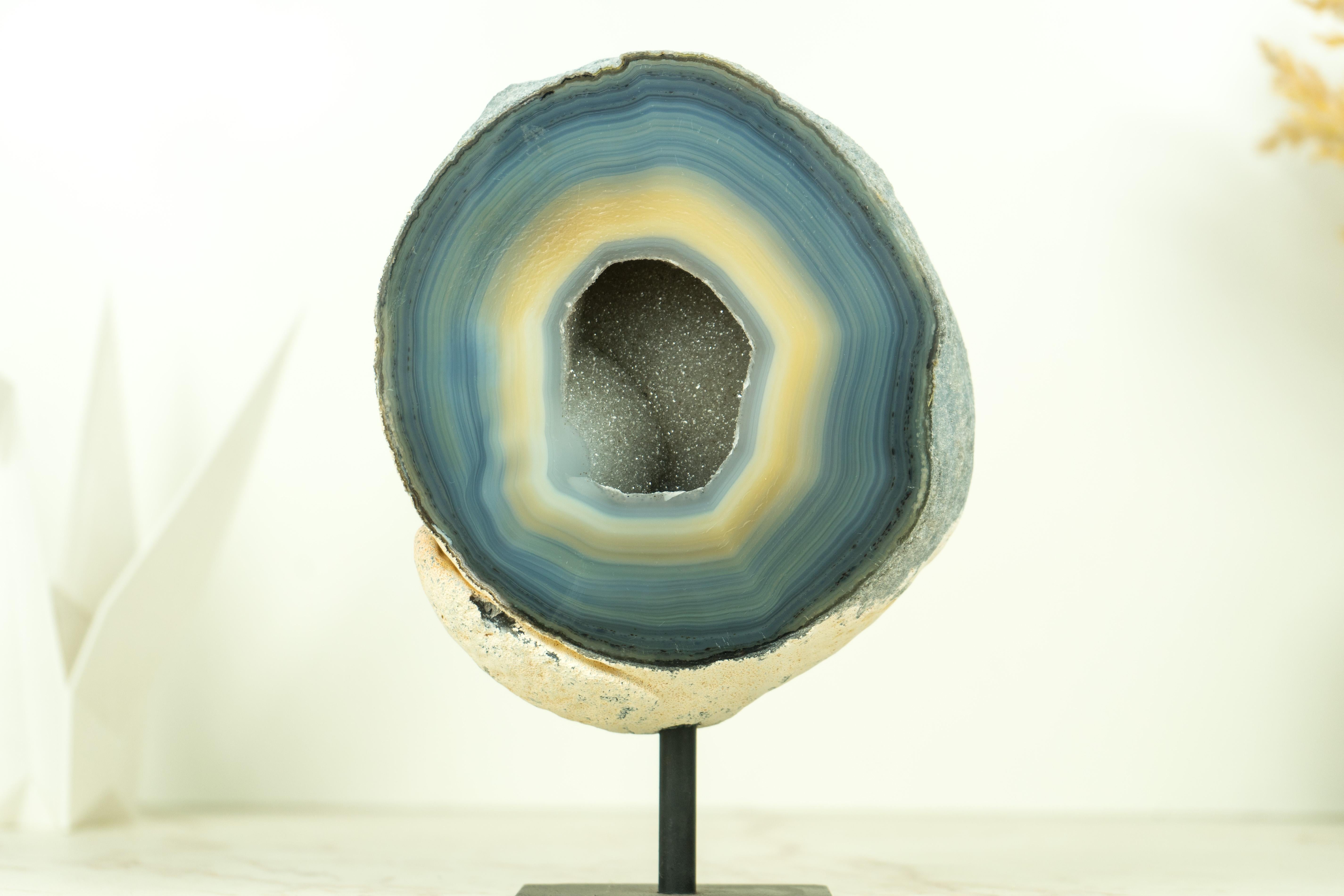 A beautiful small agate geode showcases natural blue agate laces (also known as Blue Lace Agate), rare cream-colored agate, and a gorgeous sugar druzy interior. This geode is considered exceptionally unique and superior due to the quality of the